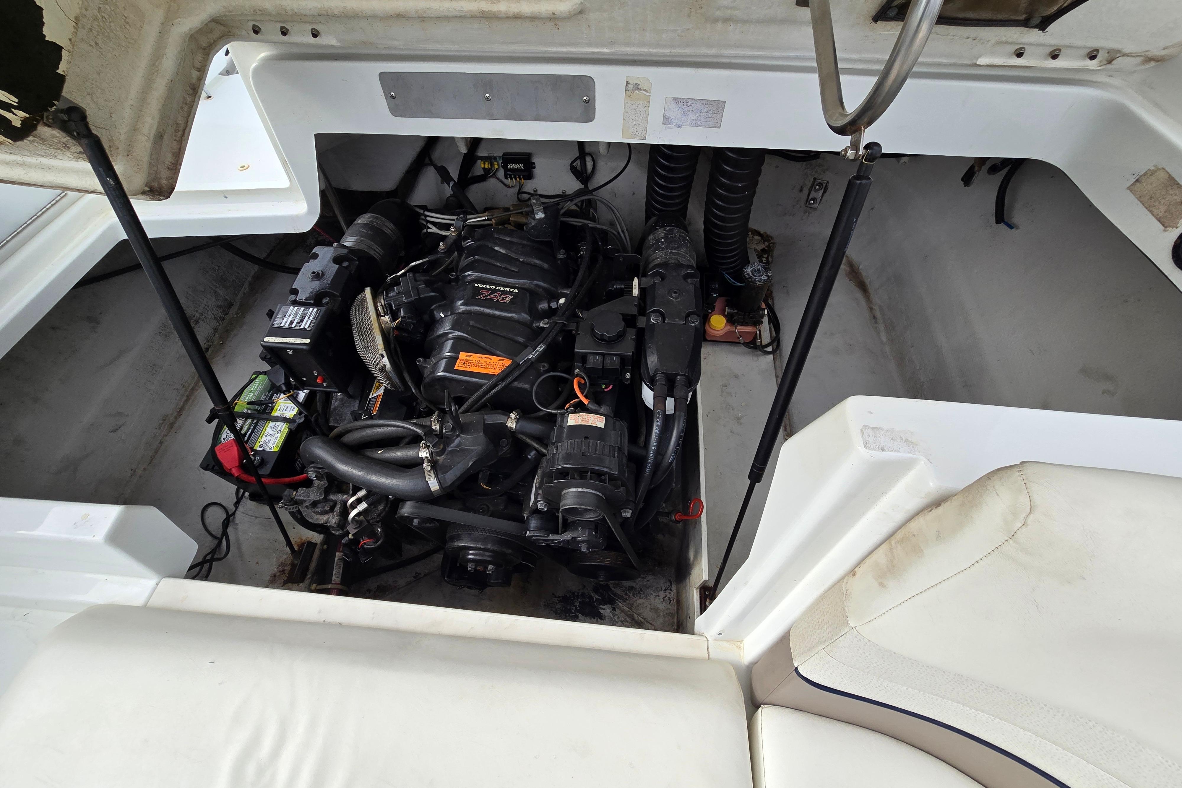 Engine compartment of a 2000 Cobalt 246 boat, showcasing the motor and components.