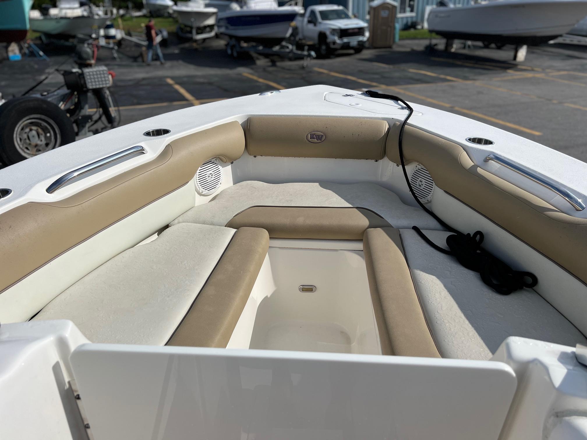 2020 Key West 239 DFS boat interior with cushioned seating and storage.