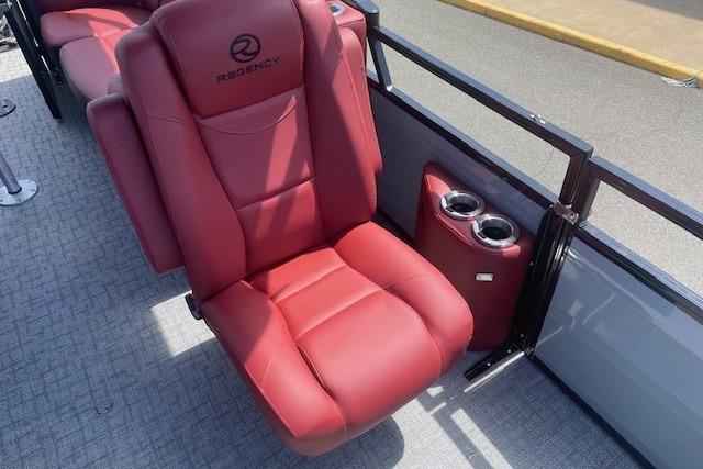 Red leather seat in 2026 Regency 250 DL boat with cup holders.