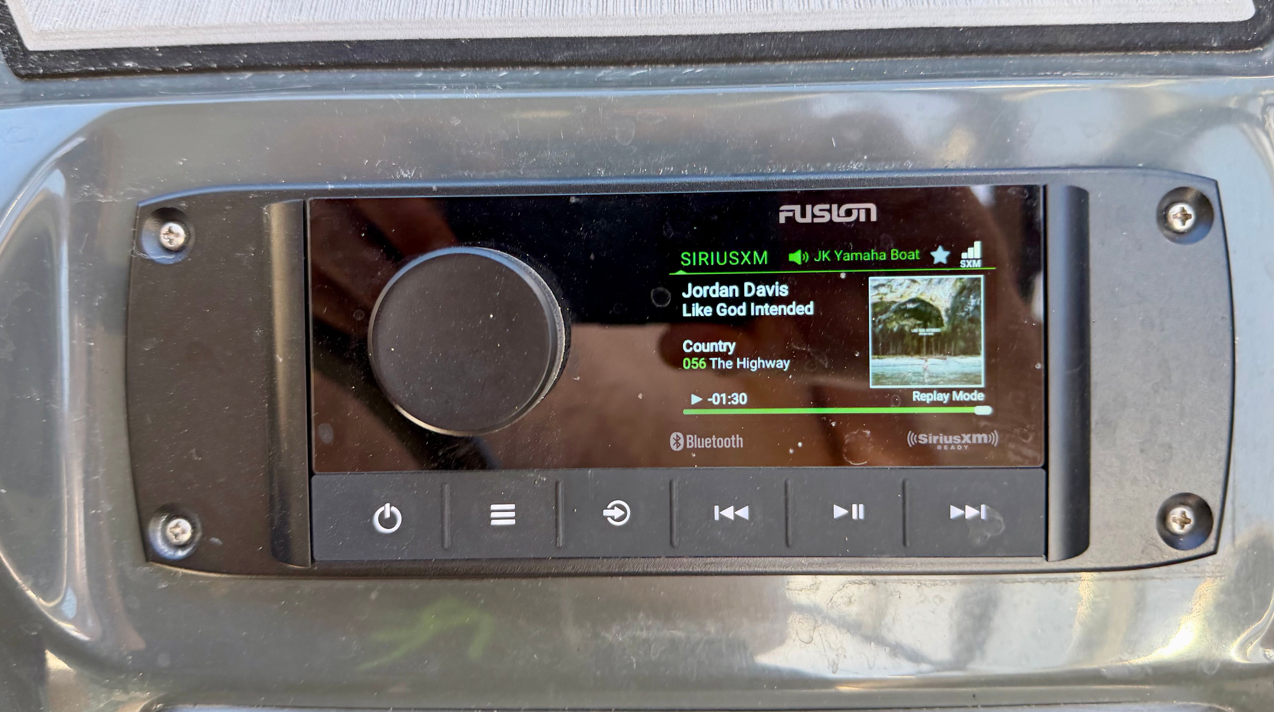 Fusion radio on Yamaha AR240 HO boat, displaying Jordan Davis song.