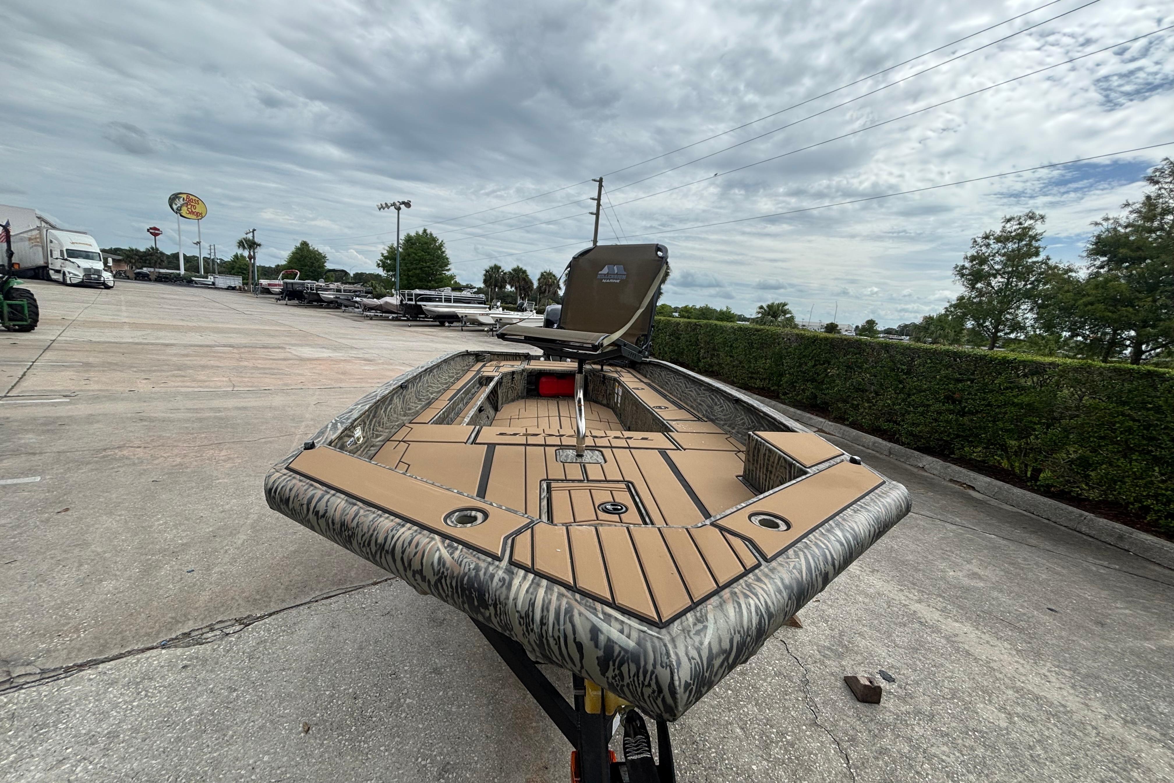2026 Tracker Grizzly 1756 T Marsh boat on trailer, parked outdoors under cloudy sky.