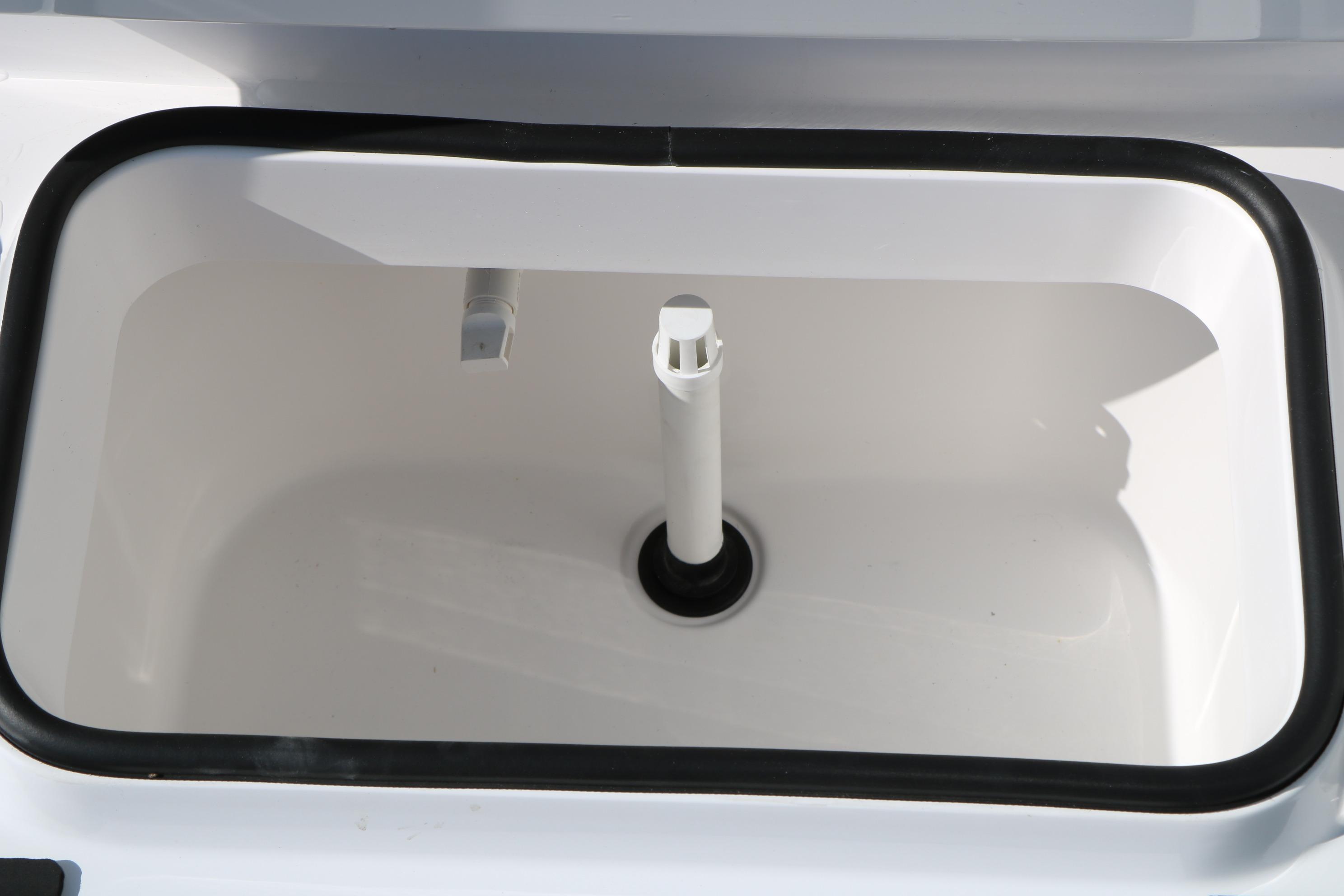 Livewell compartment of 2026 Vexus ACX2000 boat, featuring a clean, white interior.