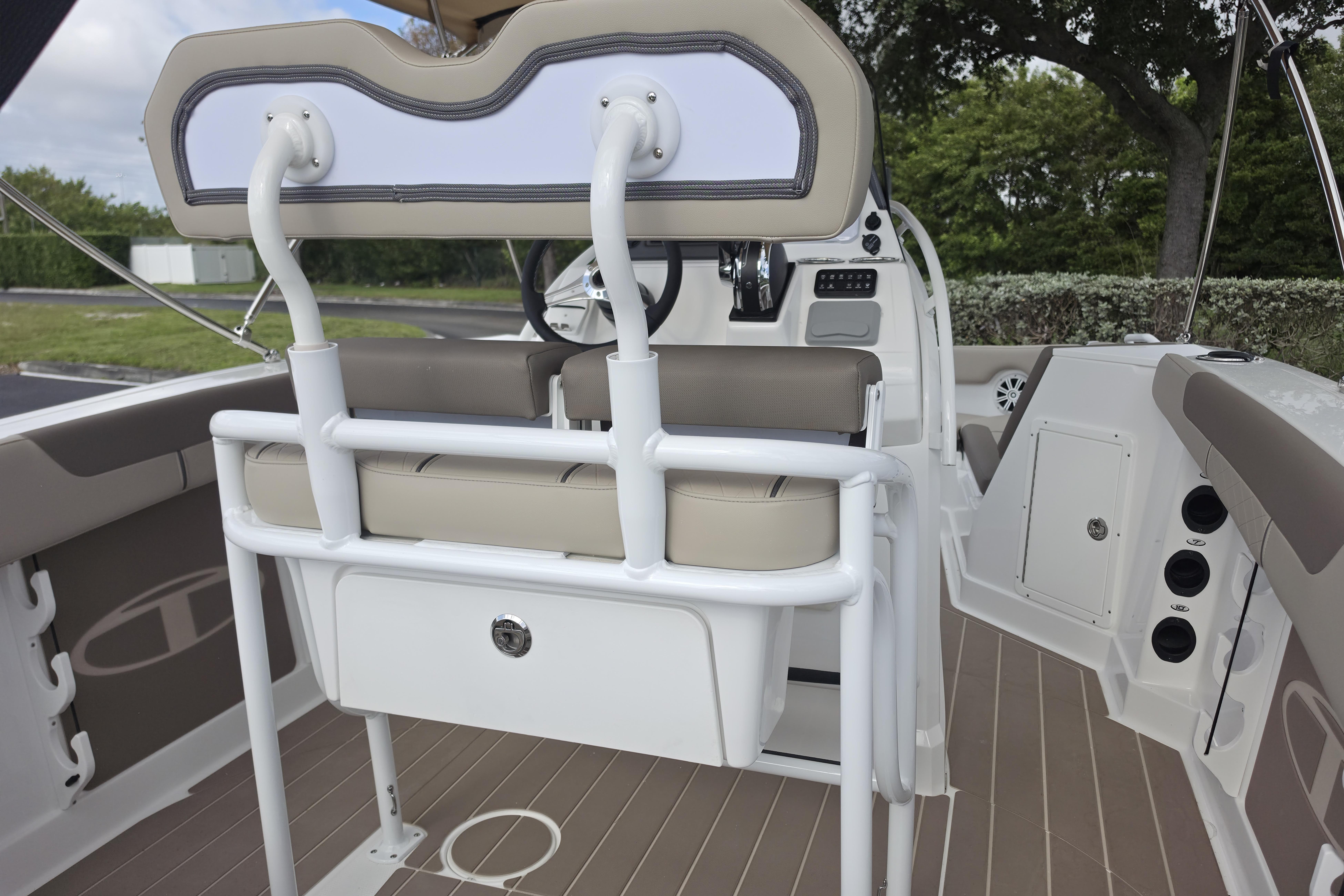 Interior view of 2026 Tahoe 2150 CC boat, featuring seating and control panel.