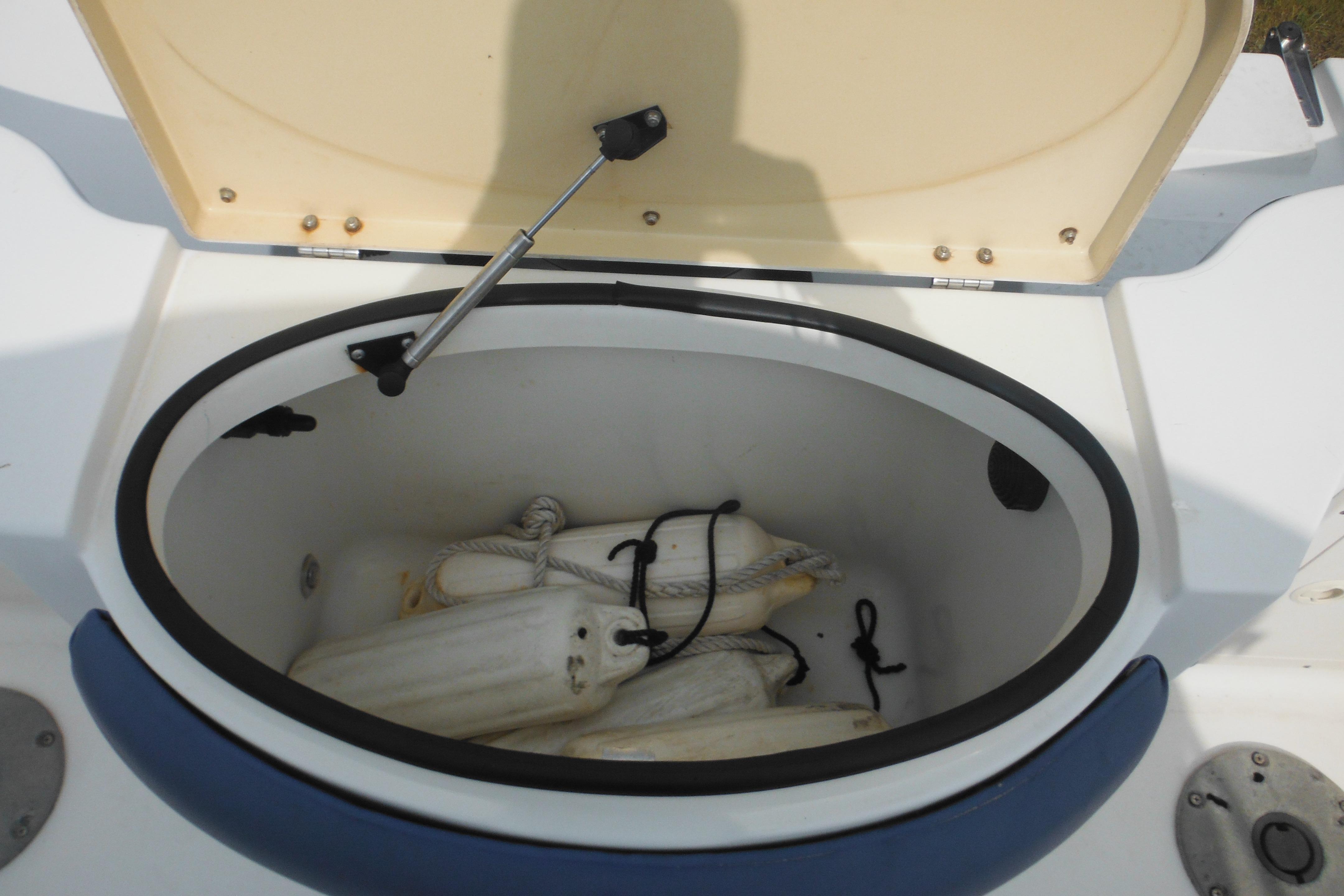 Open storage compartment on 2005 Seaswirl Striper 2101 Walkaround O/B with boat fenders inside.