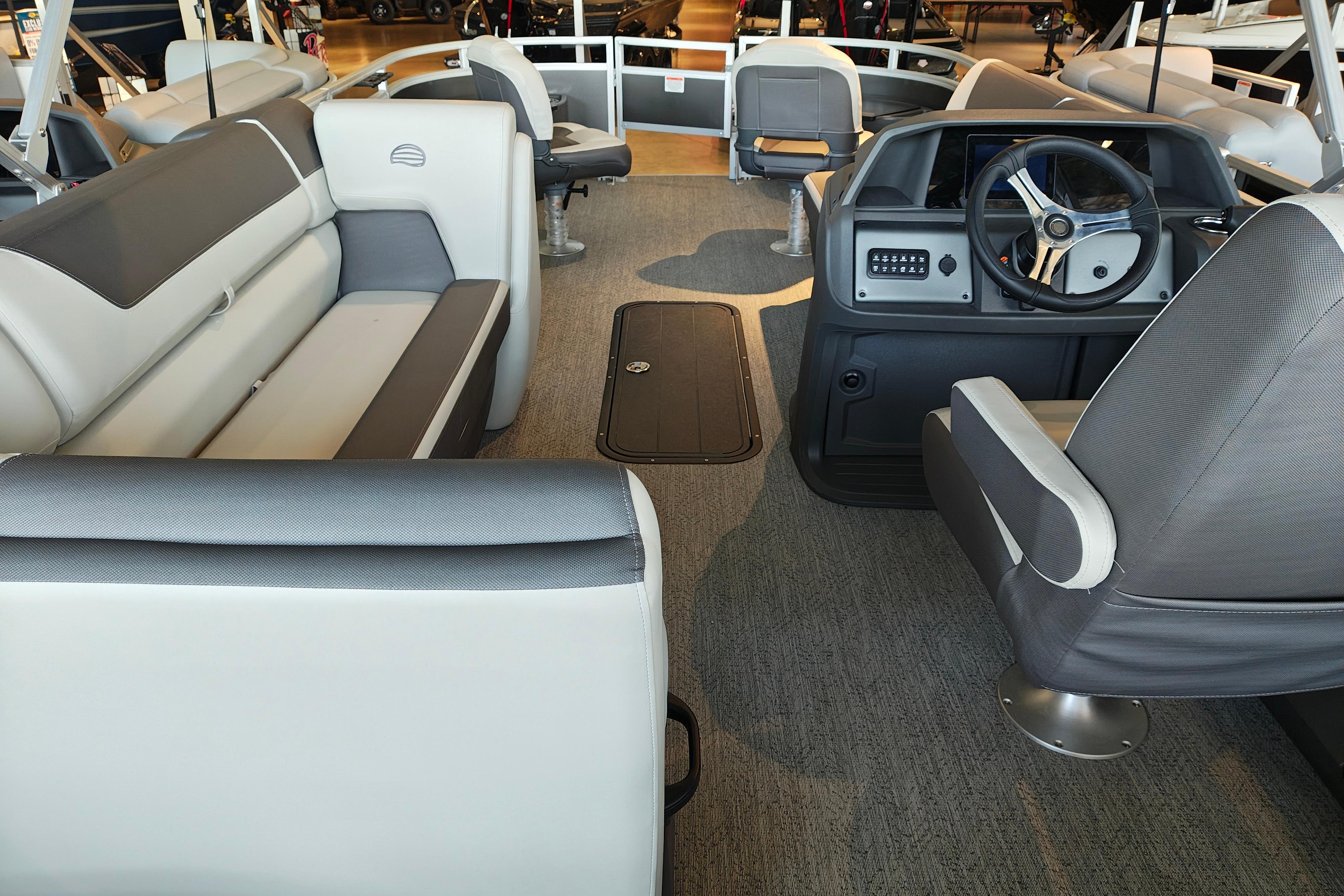 Interior of 2026 Sun Tracker Fishin' Barge 22 XP3, featuring spacious seating and modern helm.