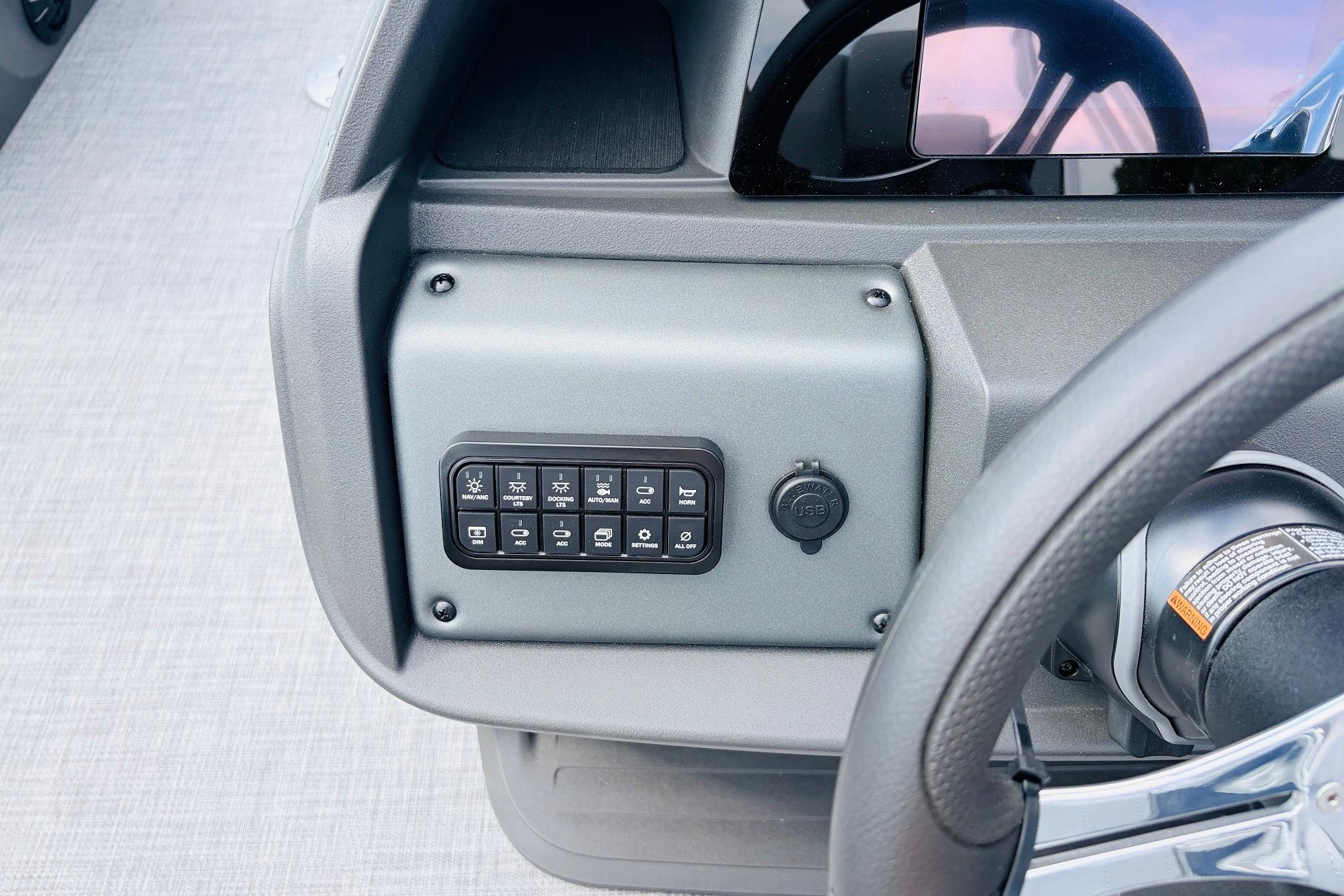 Dashboard controls of 2026 Sun Tracker SportFish 22 DLX boat with USB port.