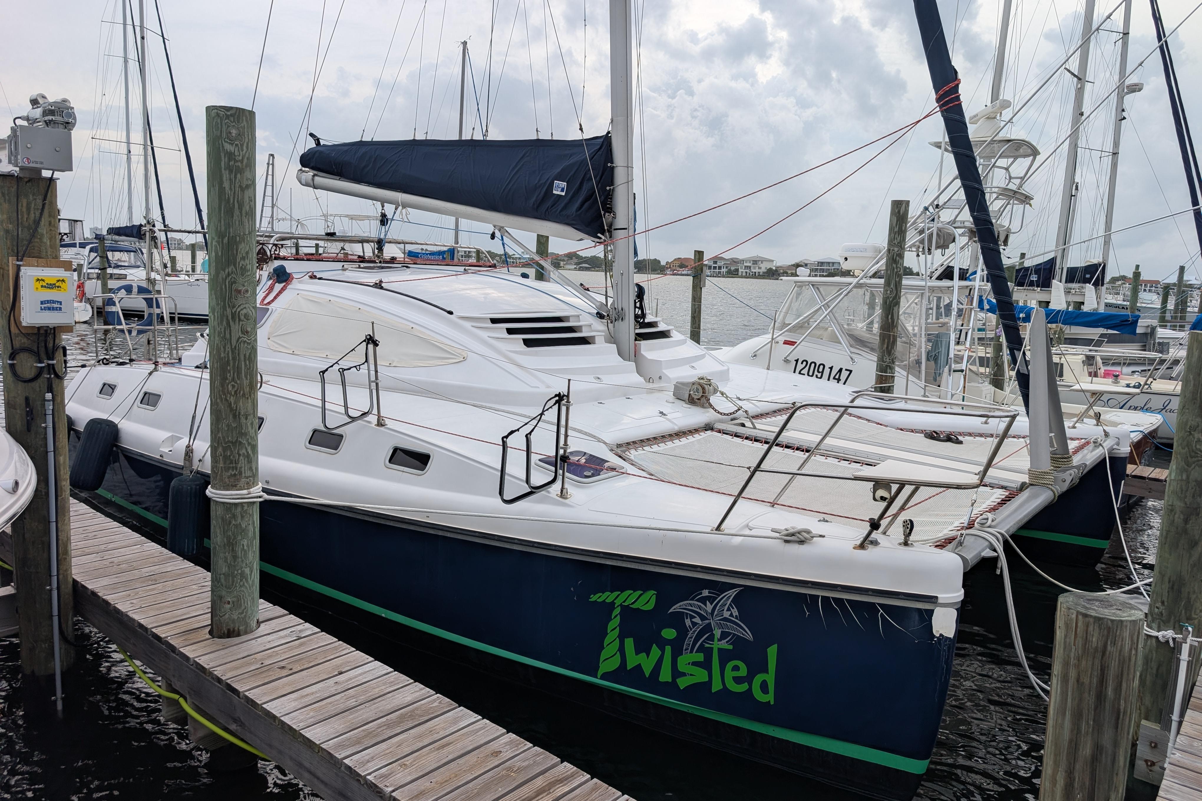 Catamaran Island Spirit 37, 1999 model, docked at marina with overcast sky.