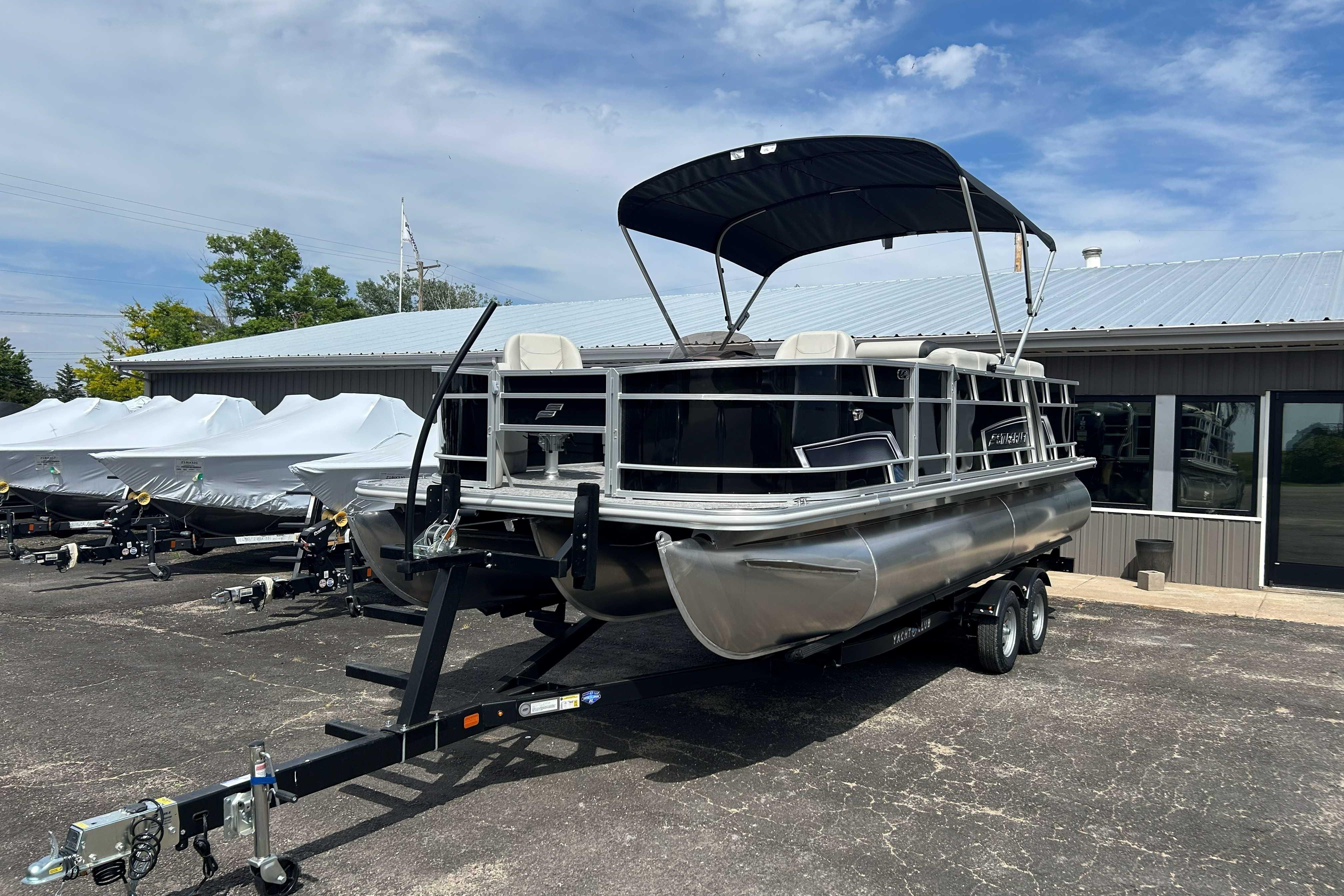 2026 Starcraft EX 22 FD pontoon boat on trailer, parked outside dealership.