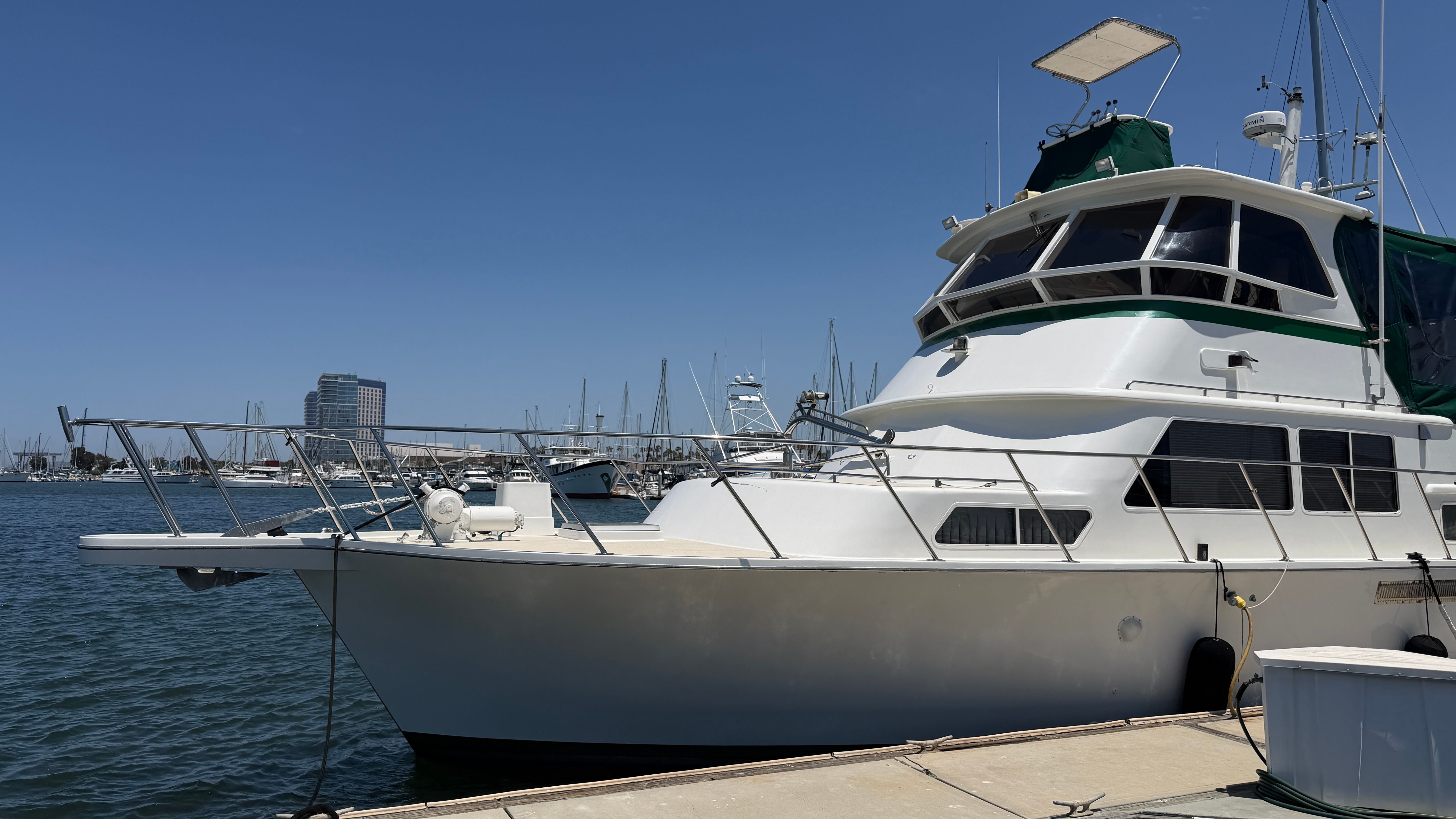 1966 Drake Yachtfisher docked at marina on sunny day.