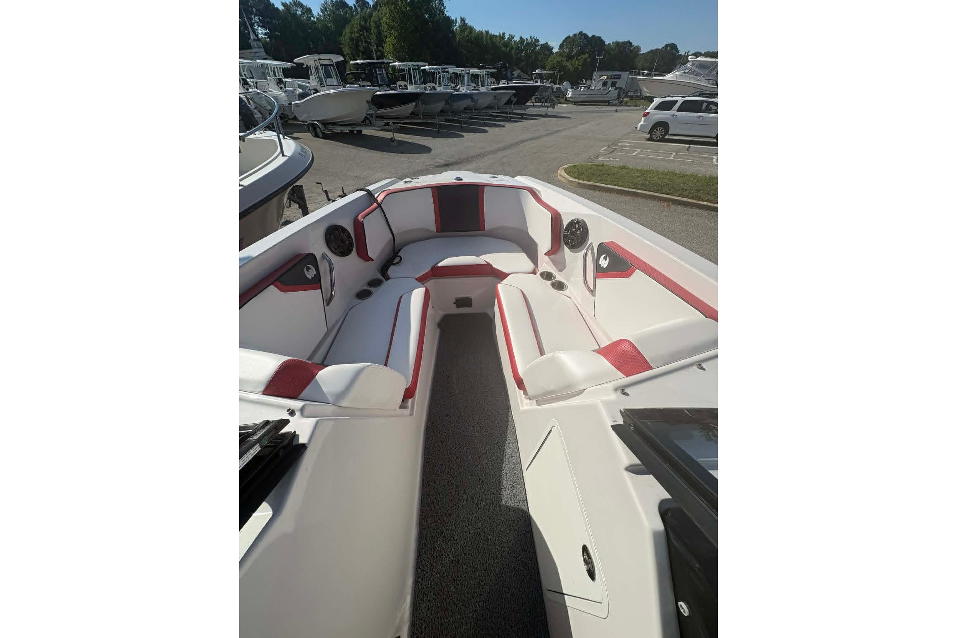2016 Scarab 255 H.O. Impulse boat interior with red and white seating, docked outdoors.