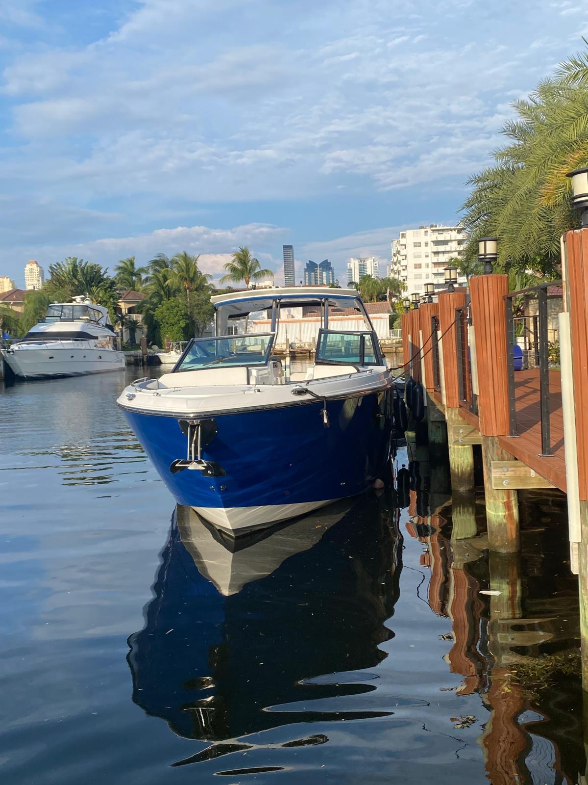 2019 Monterey 378 boat docked by waterfront with cityscape background.