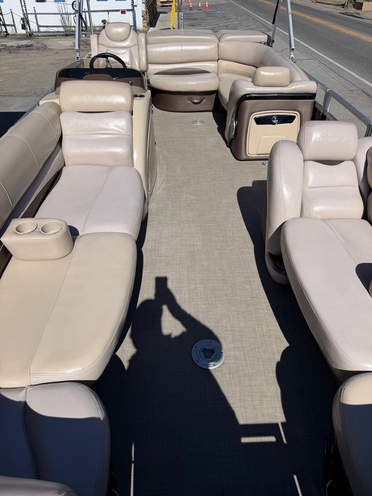Interior of a 2015 Regency 220DL3 pontoon boat with beige leather seating.