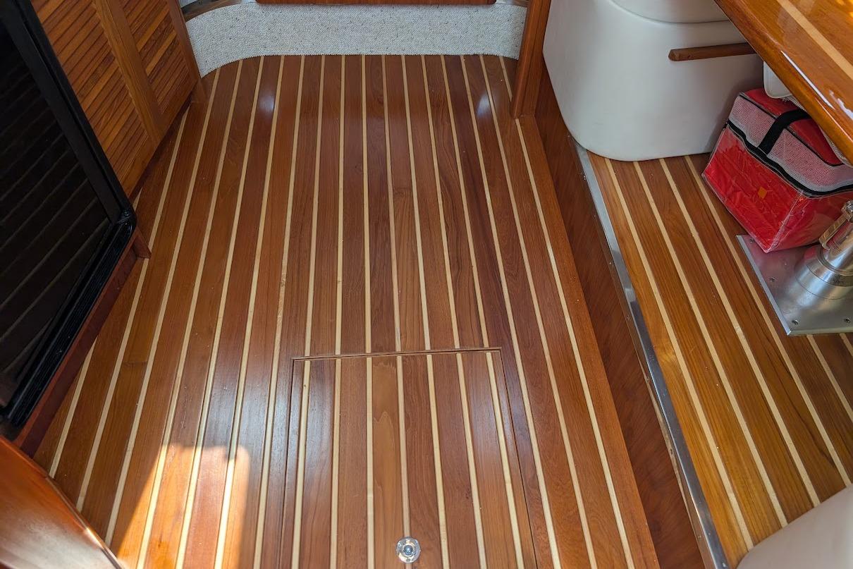 Teak and holly flooring in a 2000 Pursuit 3400 Express boat interior.