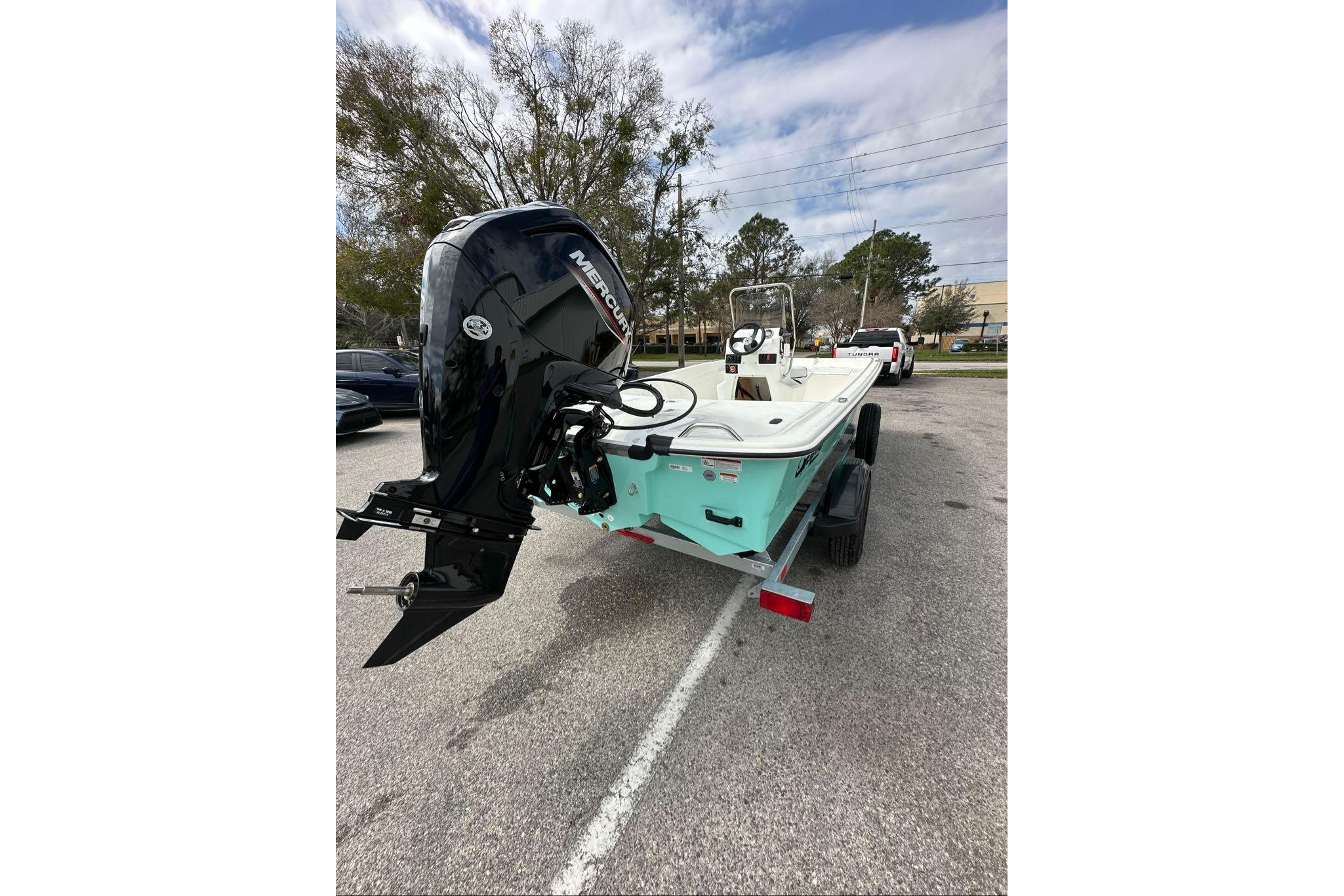 2026 Mako Pro Skiff 17 CC boat with Mercury outboard motor on trailer.