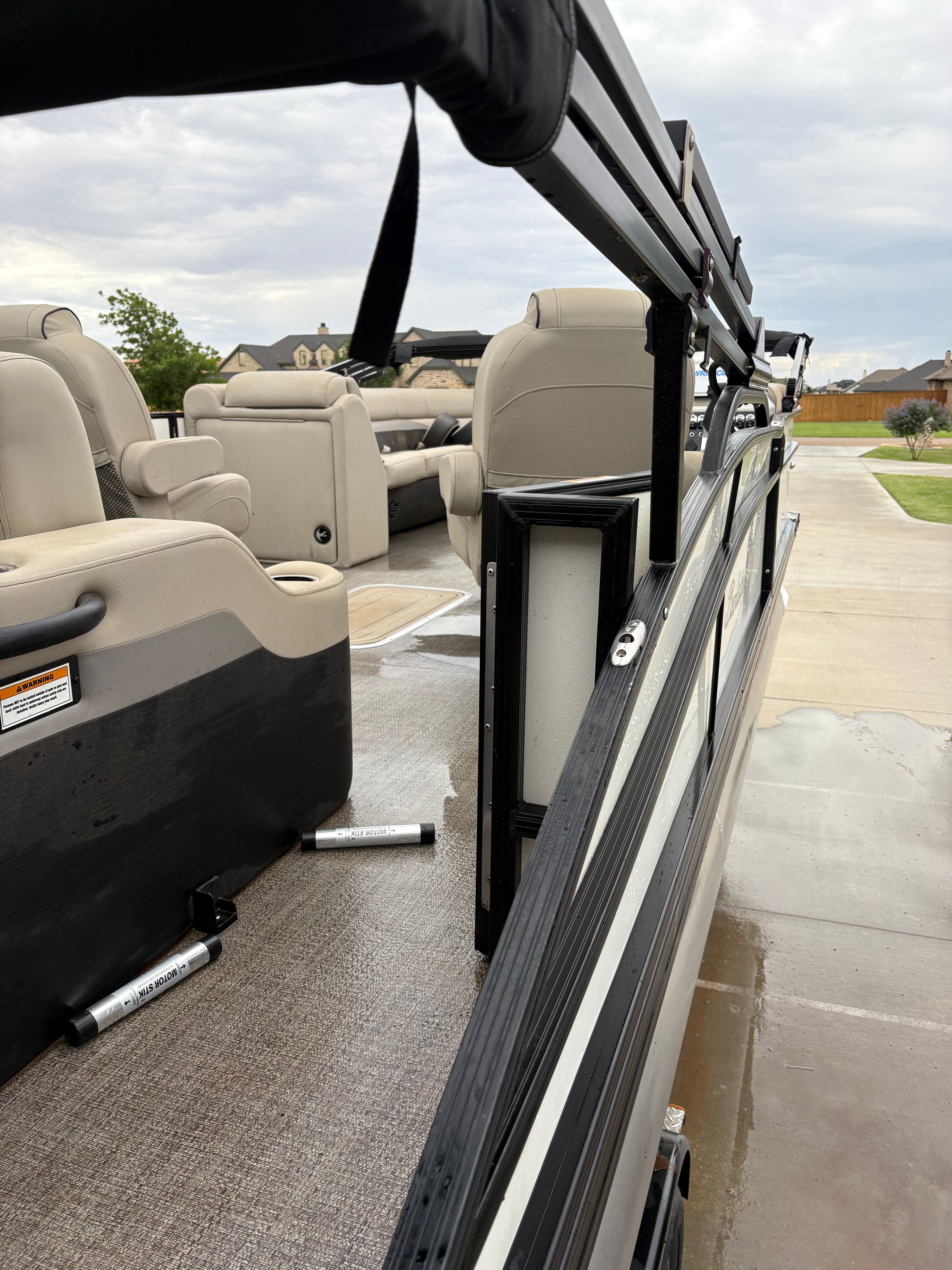 2021 Barletta C24UC pontoon boat with beige seats and black railing.