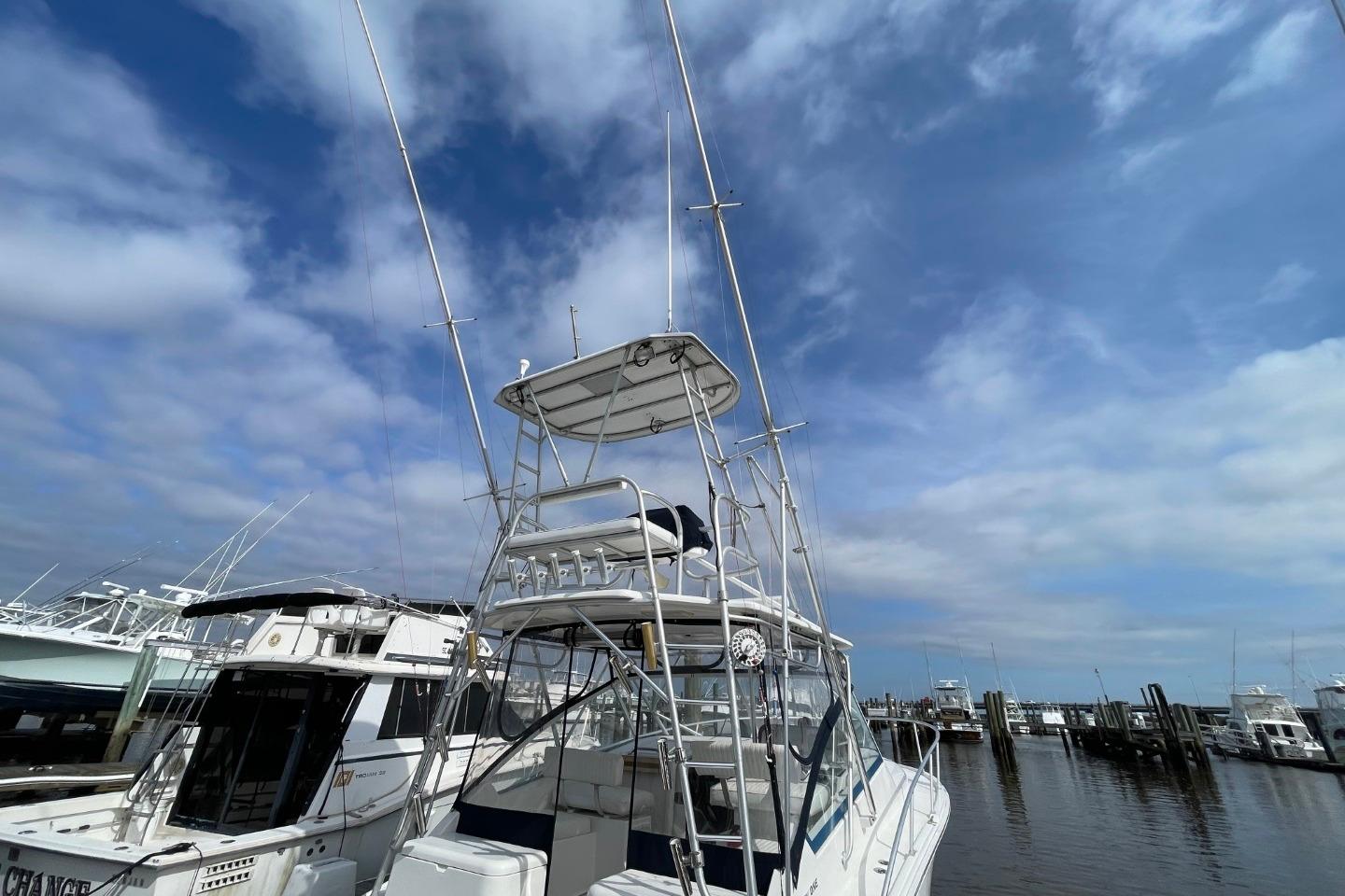 2007 Luhrs 31 Open boat docked under a partly cloudy sky.