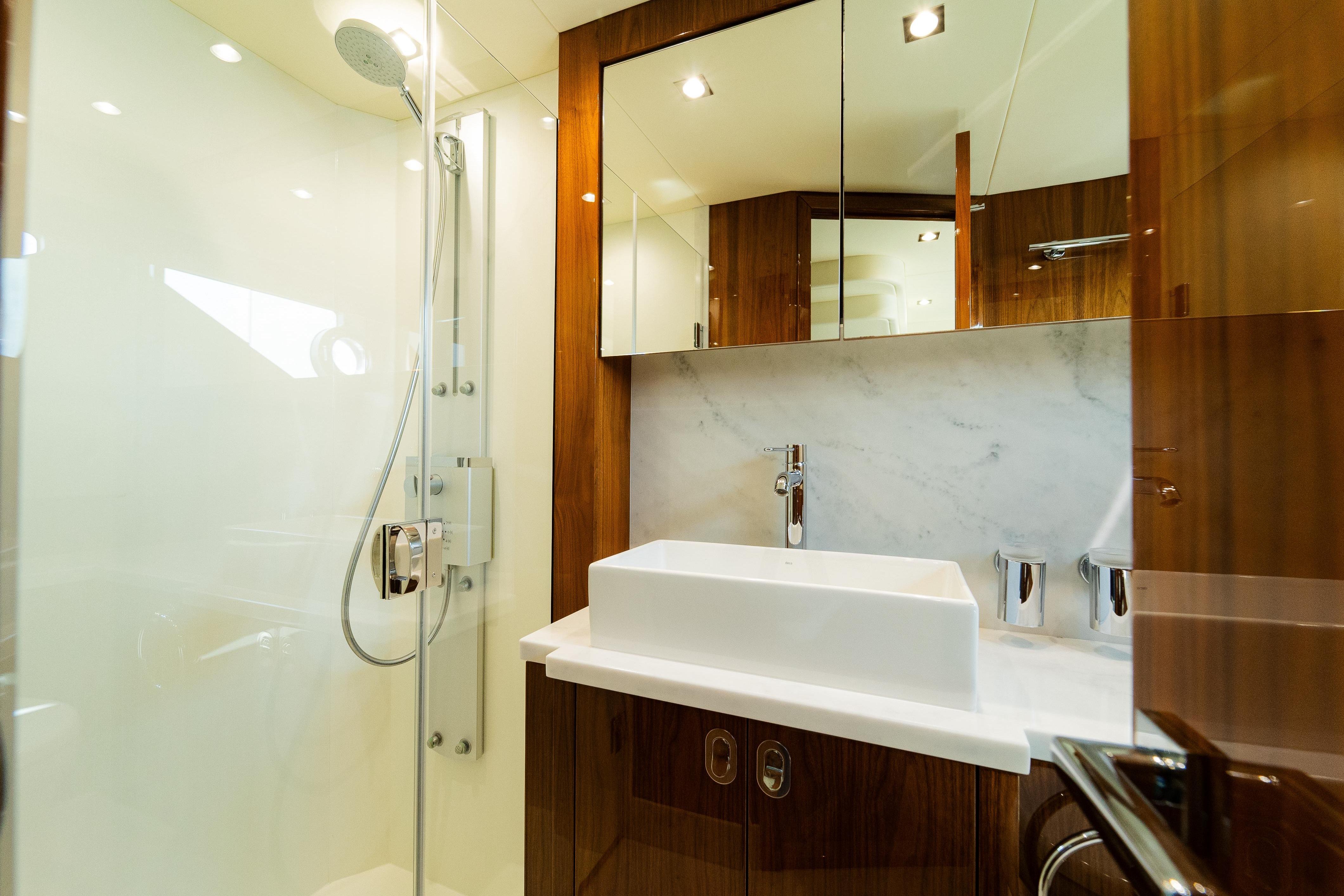 Luxurious bathroom in 2016 Sunseeker Manhattan 65 yacht with modern fixtures and elegant design.