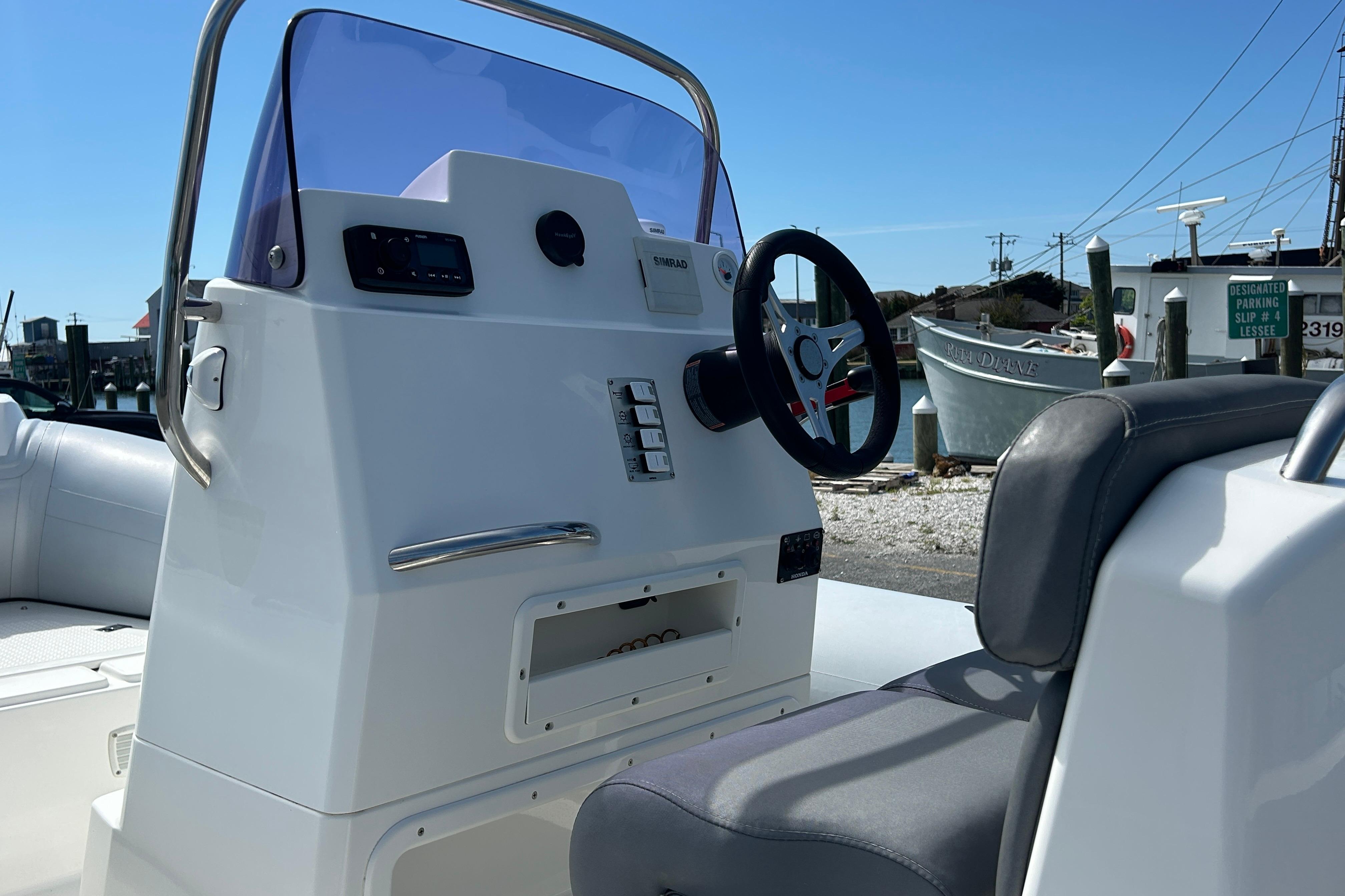 Steering console of a 2016 Brig Navigator 520 boat, featuring modern controls and seating.