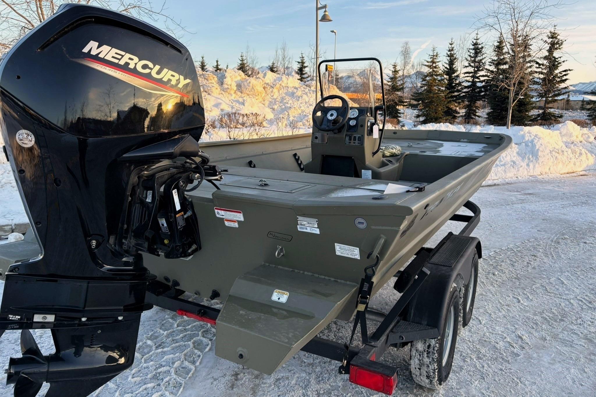 2024 Tracker Grizzly 2072 CC boat with Mercury engine, parked on snowy ground.