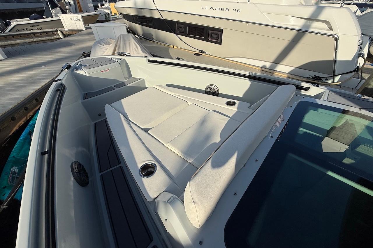 2024 Saxdor 320 GTC boat with spacious deck and comfortable seating at a marina.