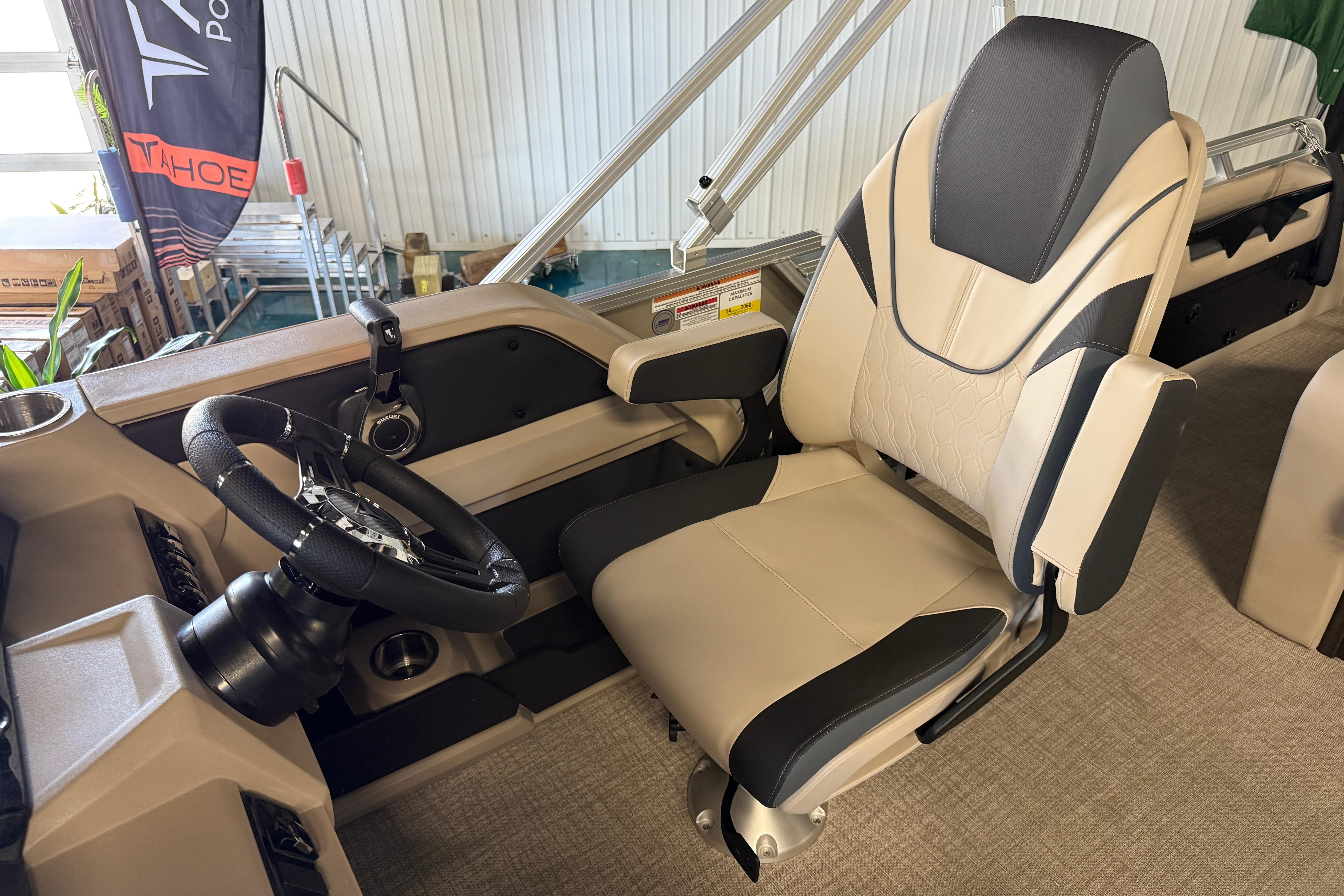 Captain's chair and steering wheel of 2026 Tahoe Pontoon LTZ Entertainer boat.