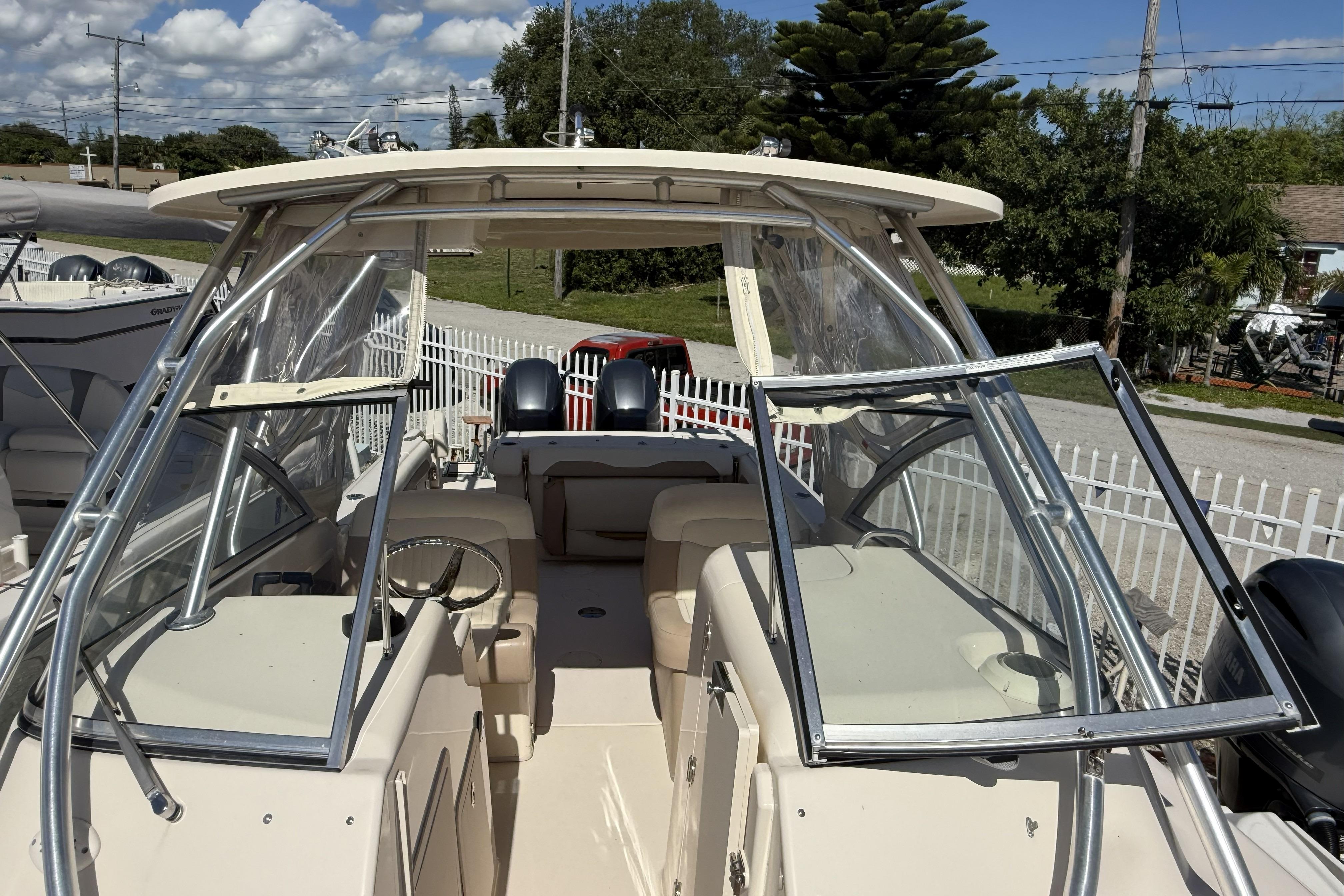 2014 Grady-White Freedom 275 boat with open cockpit and dual engines, docked outdoors.