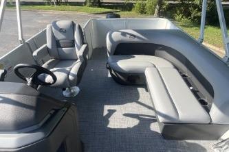 2026 Sun Tracker Party Barge 18 DLX interior with seating and steering wheel.