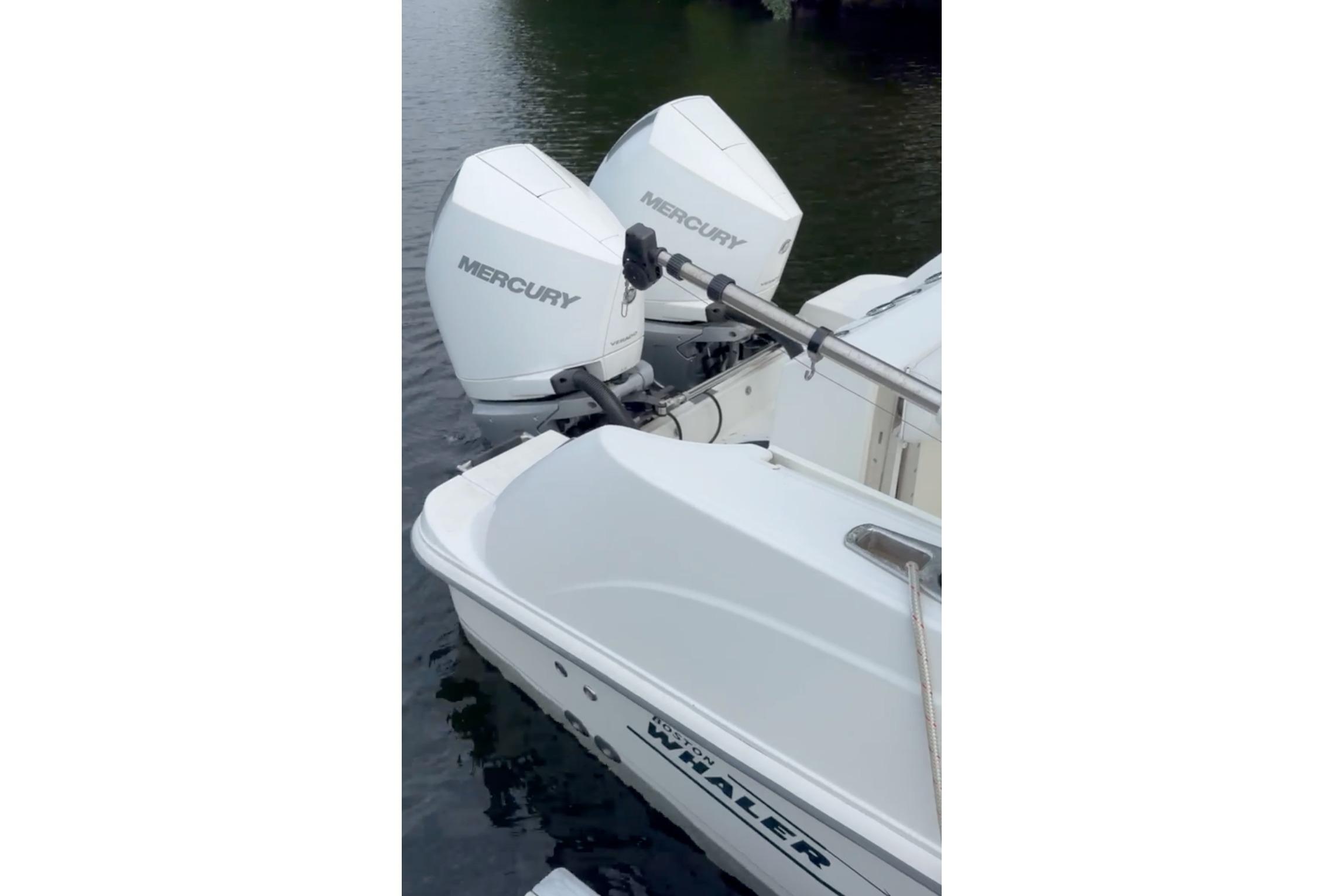2023 Boston Whaler 250 Outrage with twin Mercury outboard engines on water.