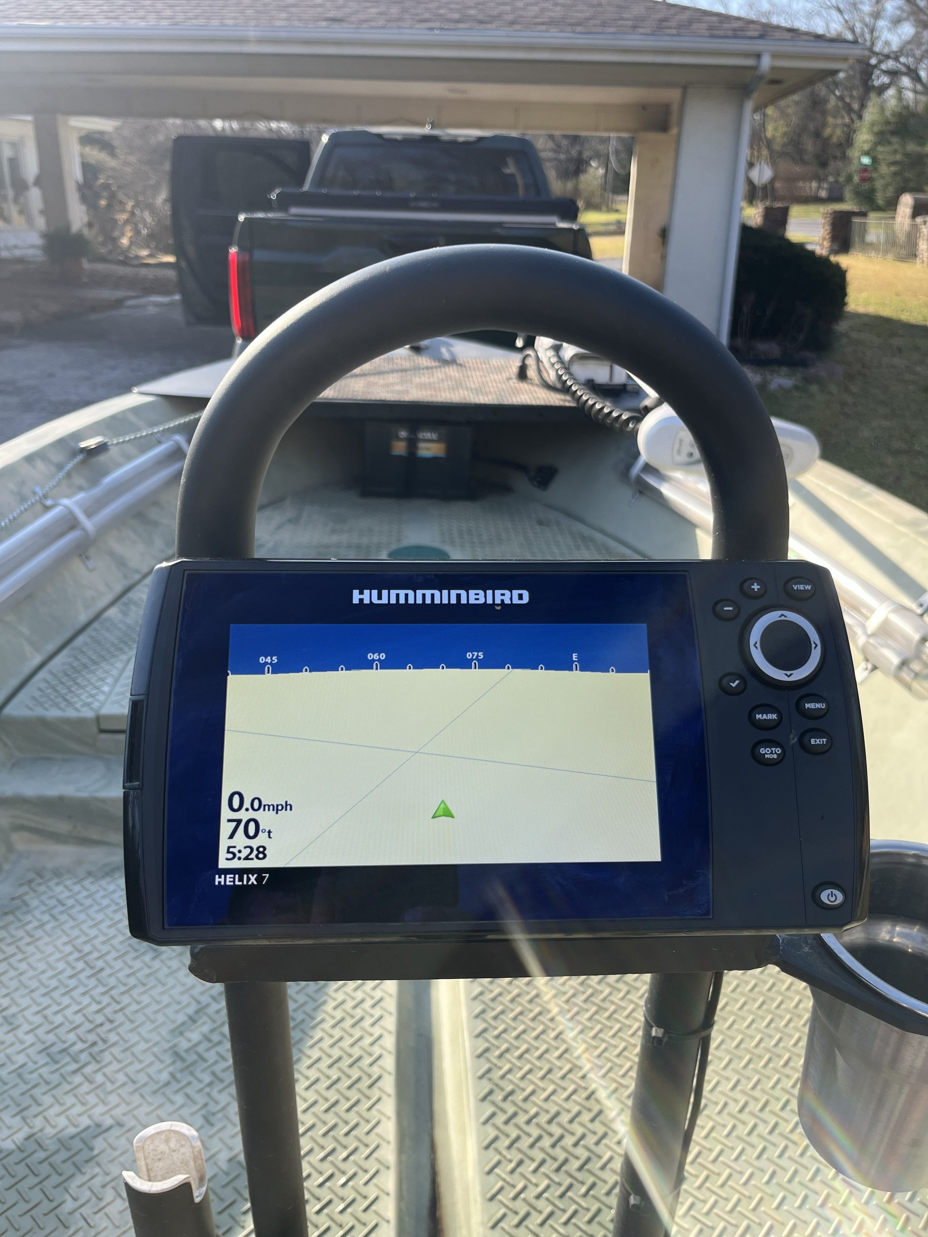 A Humminbird fish finder is mounted on a boat sitting on a trailer.