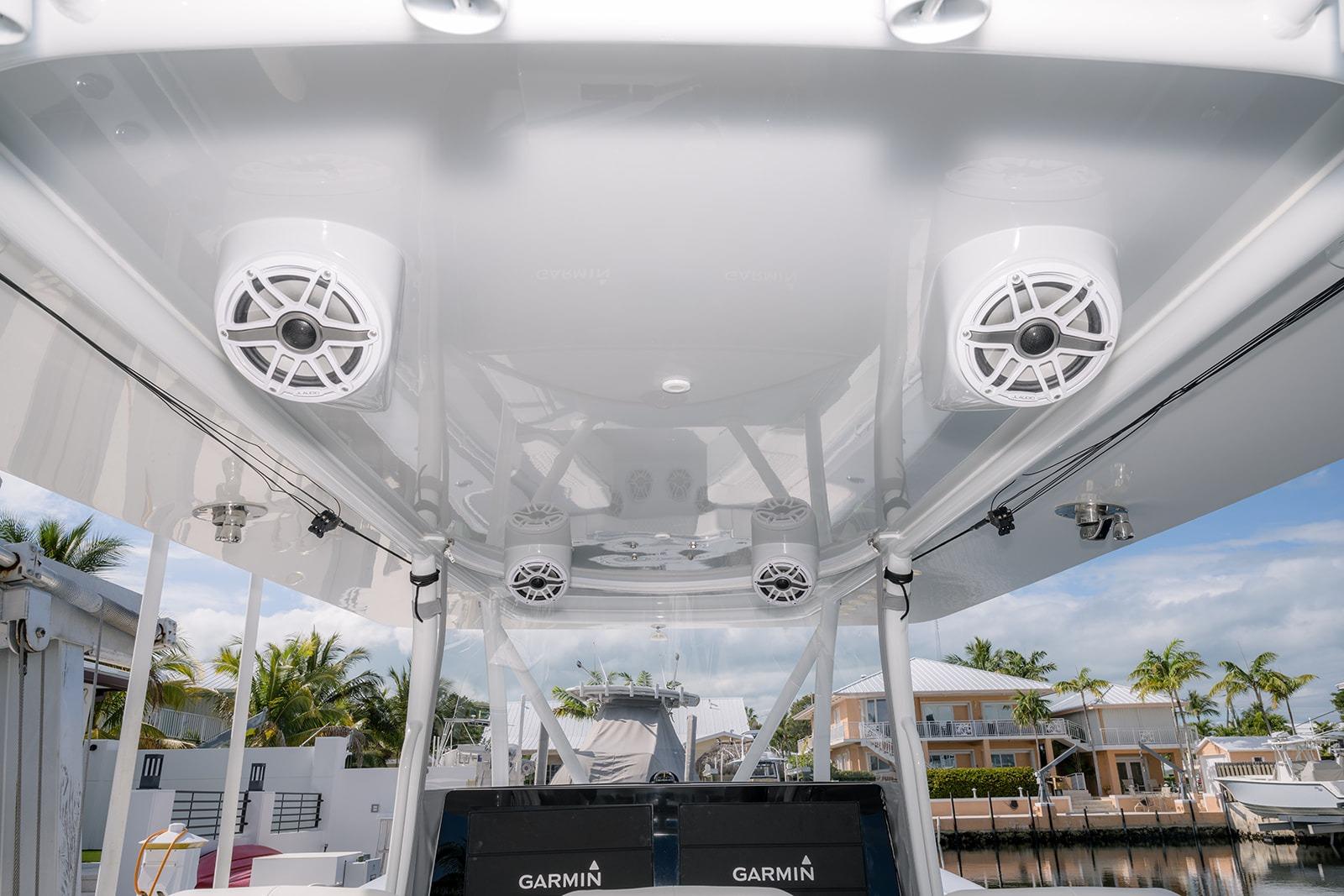 2024 Contender 44 ST boat with speakers and Garmin equipment, docked in a sunny marina.