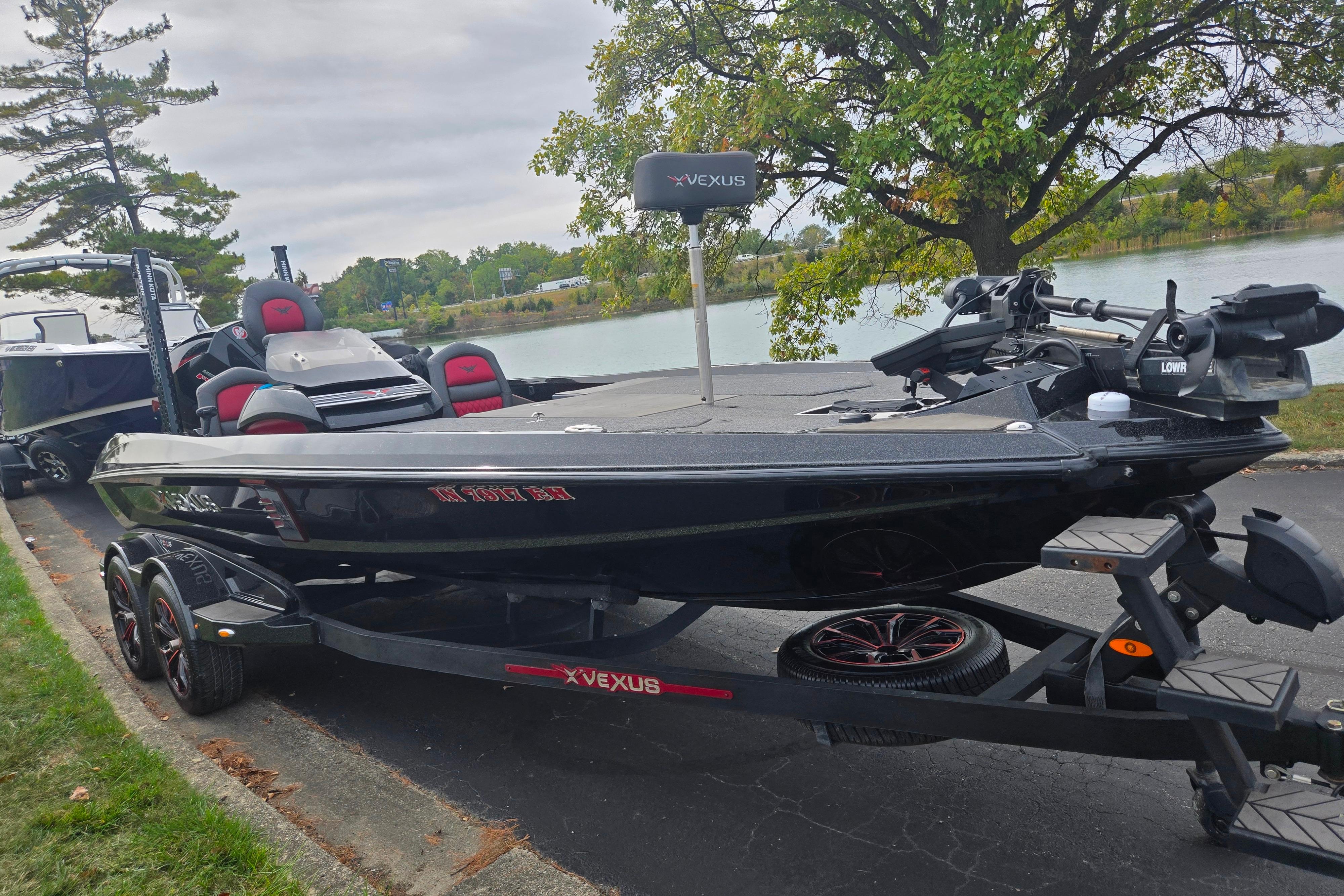 2022 Vexus VX20 boat on trailer by a lakeside, featuring sleek design and modern equipment.
