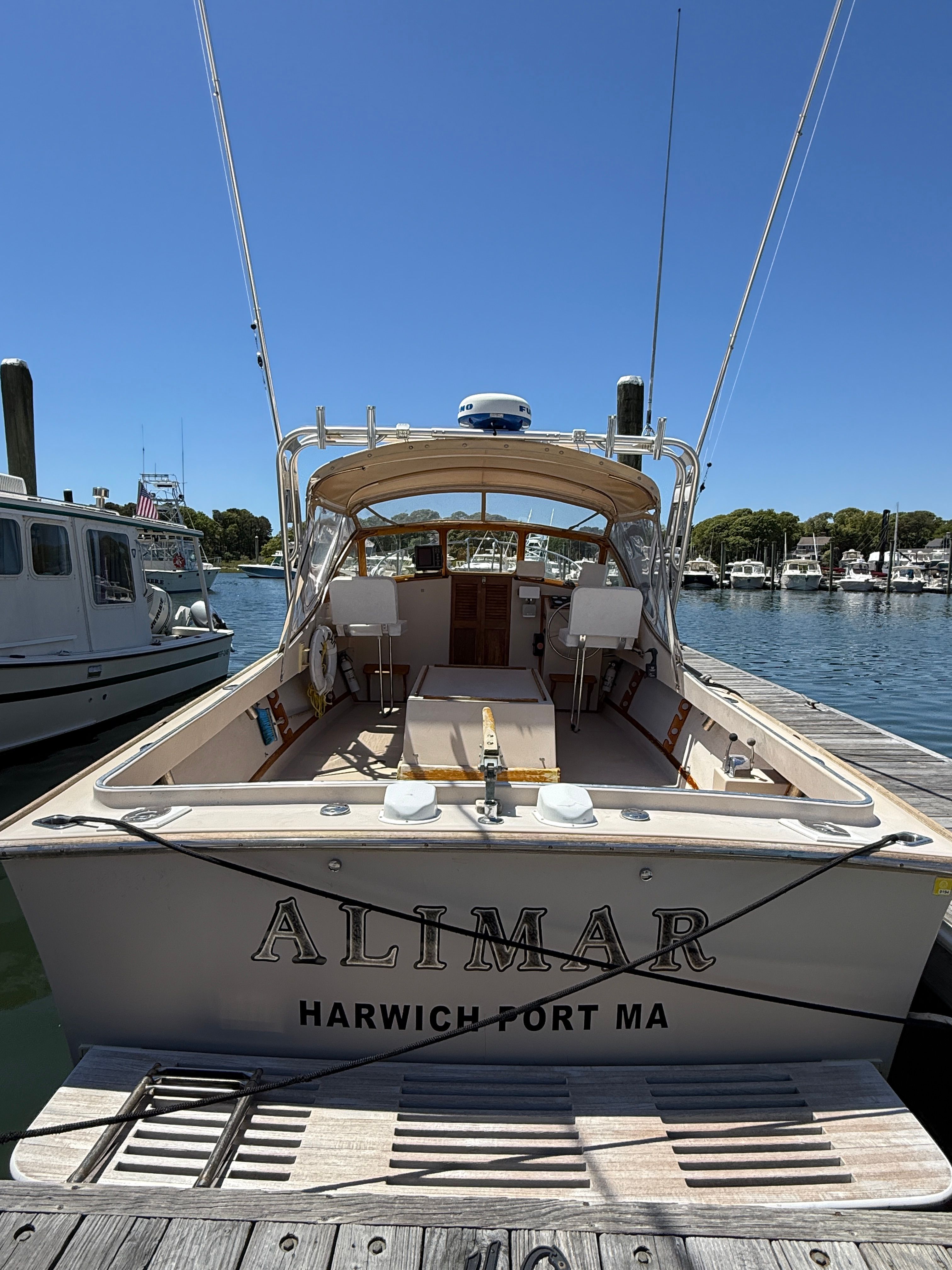 A 1989 Fortier 26 boat docked at a harbor.