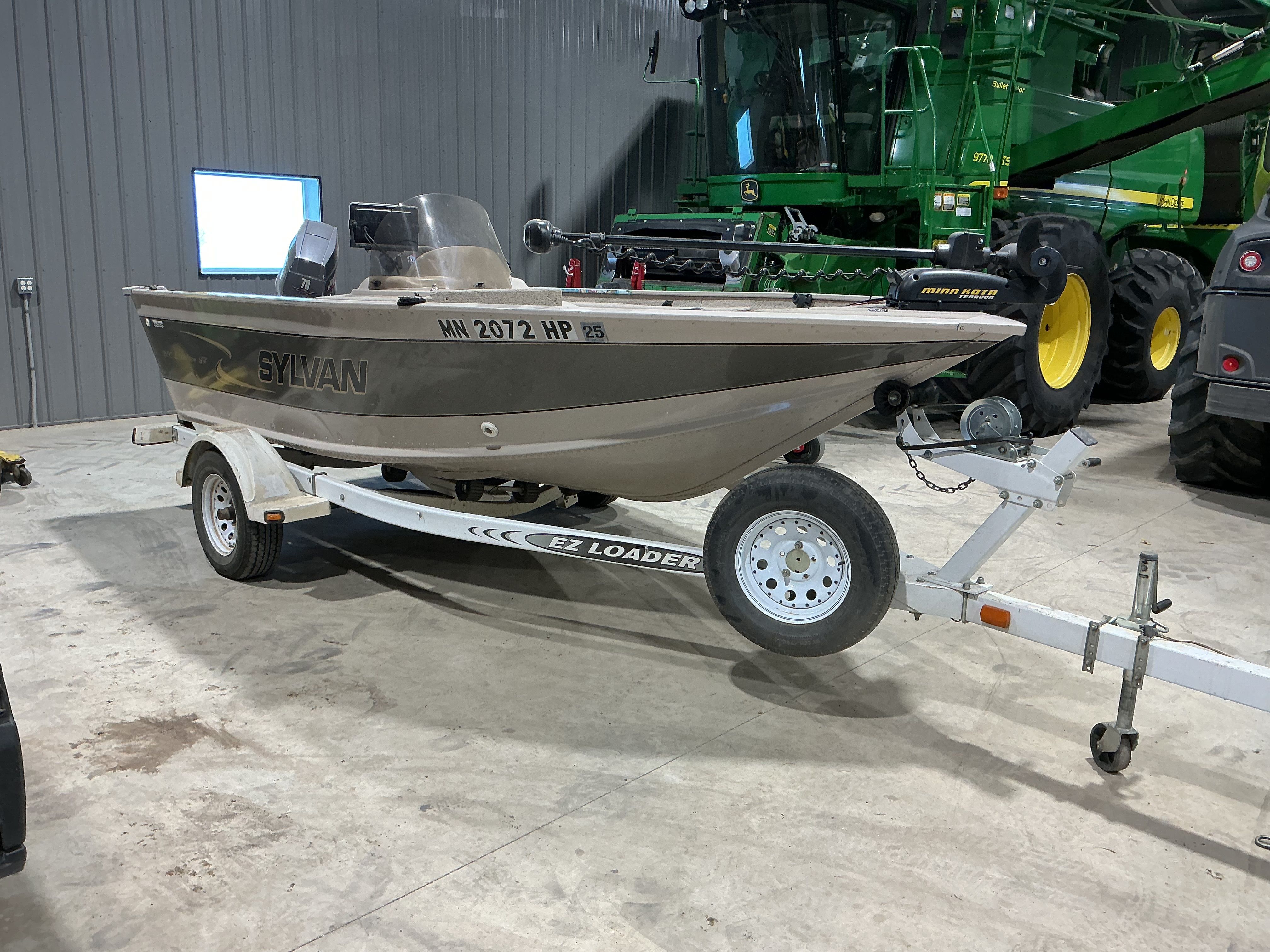 1999 Sylvan EXPEDITION boat on trailer in warehouse.