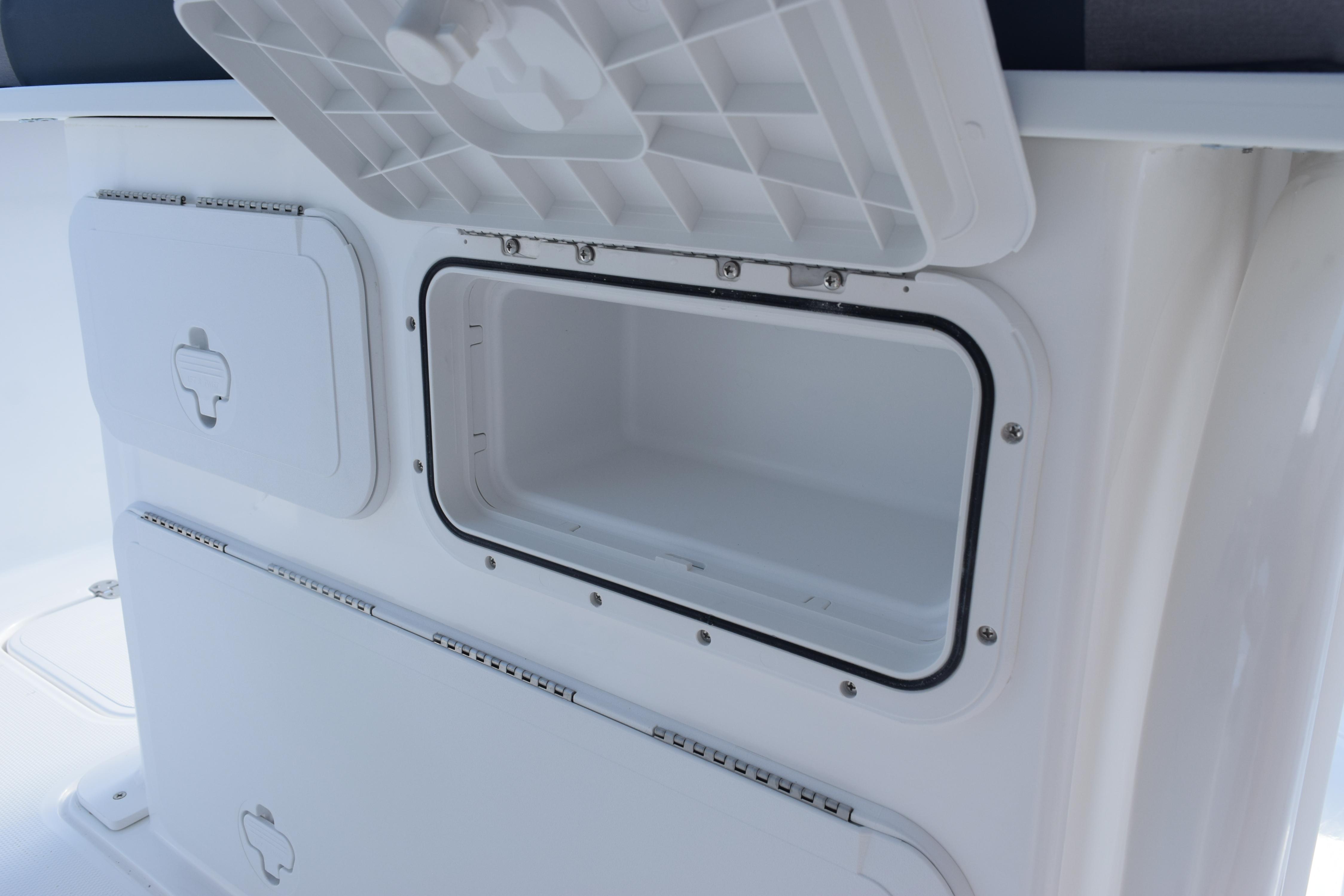 2025 Hurricane Center Console 24 OB storage compartments, open and closed, showcasing interior space.