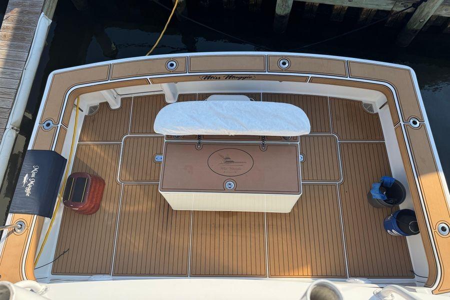 2002 Viking 61 Enclosed Bridge yacht deck with teak flooring and fishing station.