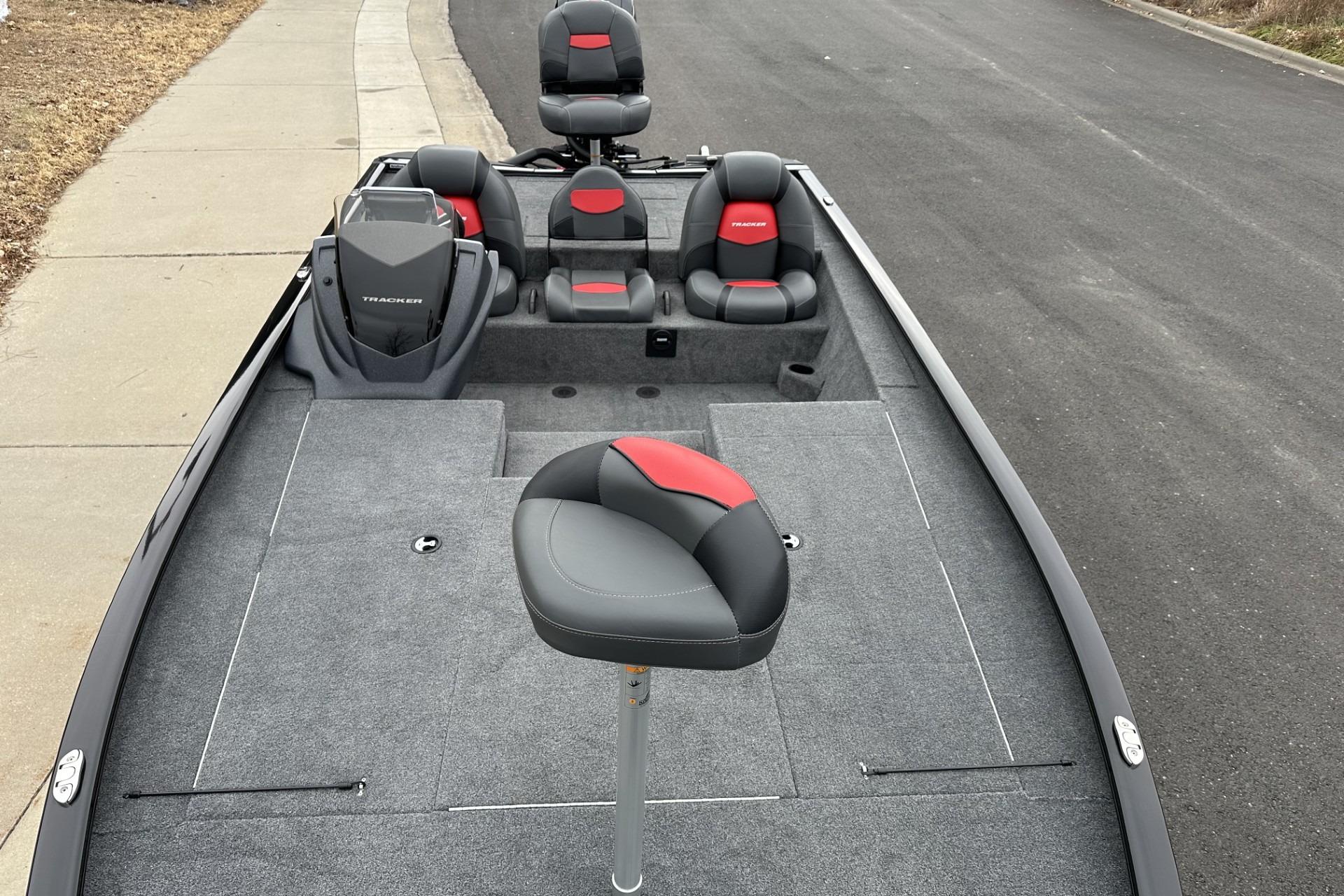 2025 Tracker Savage 215 boat with gray and red seating on a paved road.