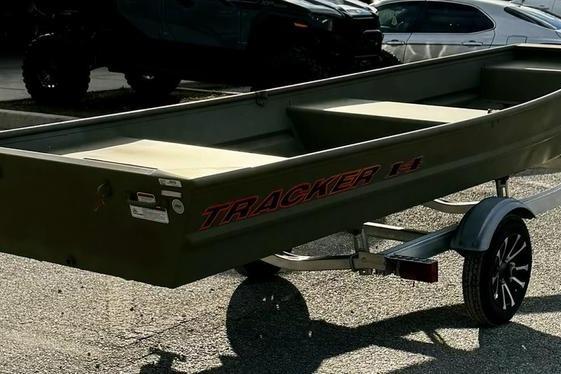 2026 Tracker Grizzly 14 Jon boat on trailer in parking lot.