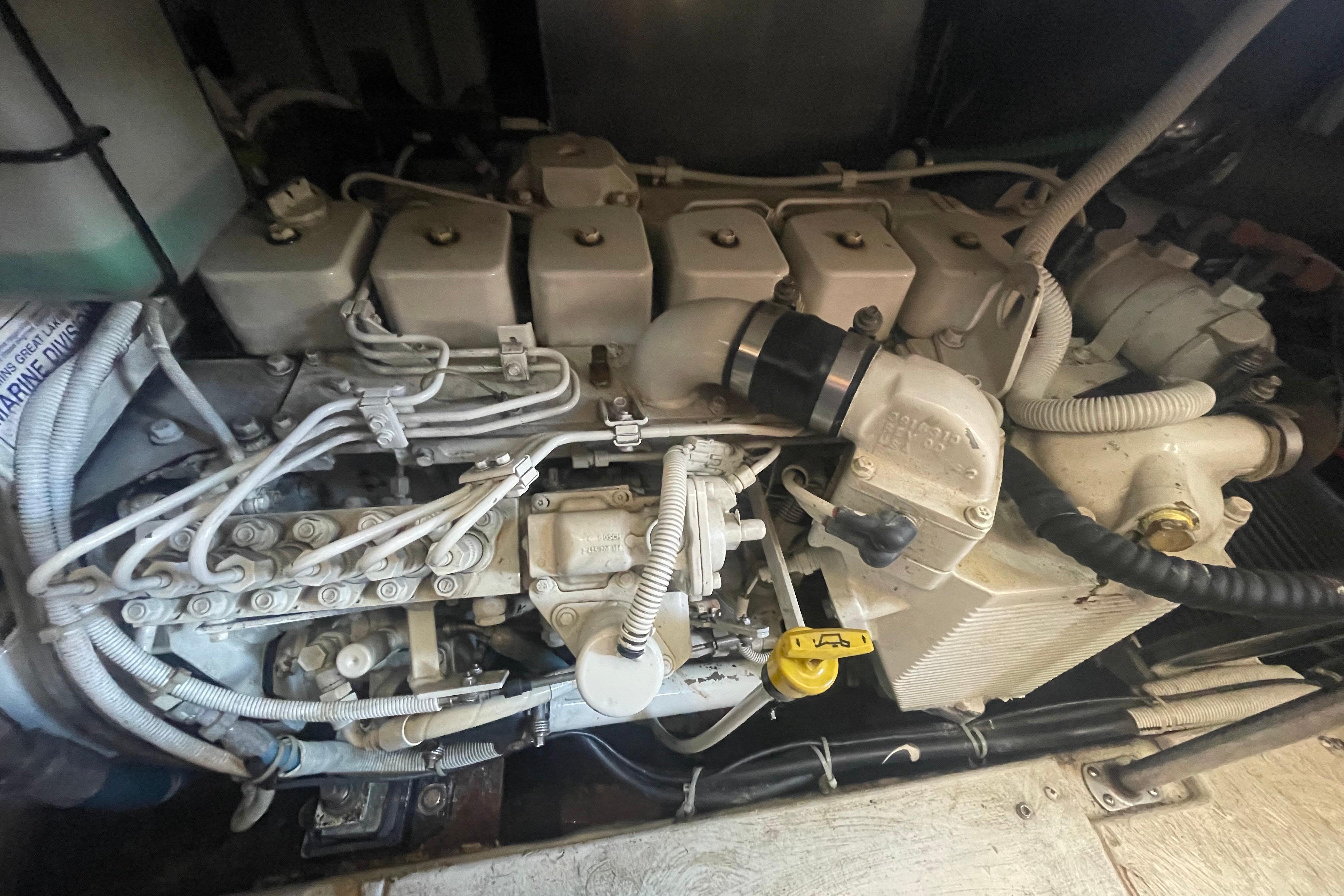 Engine compartment of a 2002 Carver 410 Sport Sedan, showcasing intricate mechanical components.