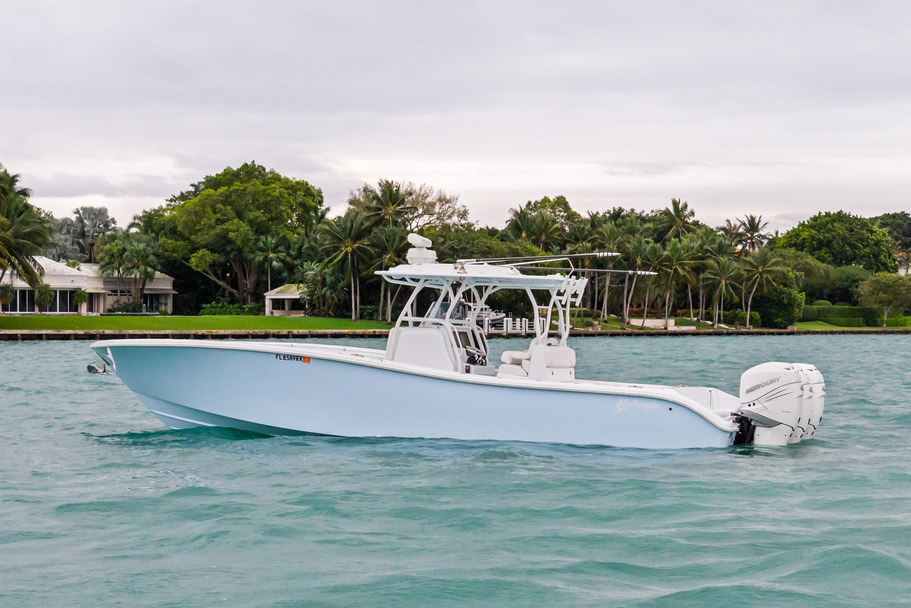 2021 Yellowfin 36 Offshore boat on turquoise water, surrounded by lush greenery.
