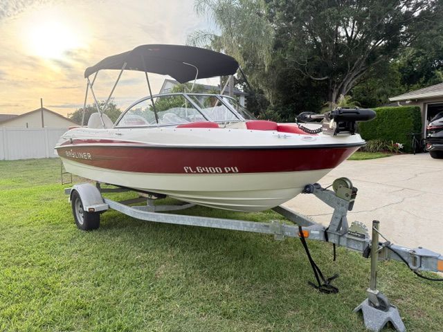 2012 Bayliner 184 SF boat on trailer in yard.