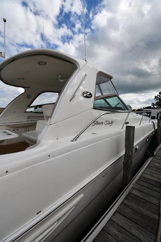 2003 Sea Ray 460 Sundancer yacht docked under cloudy skies.