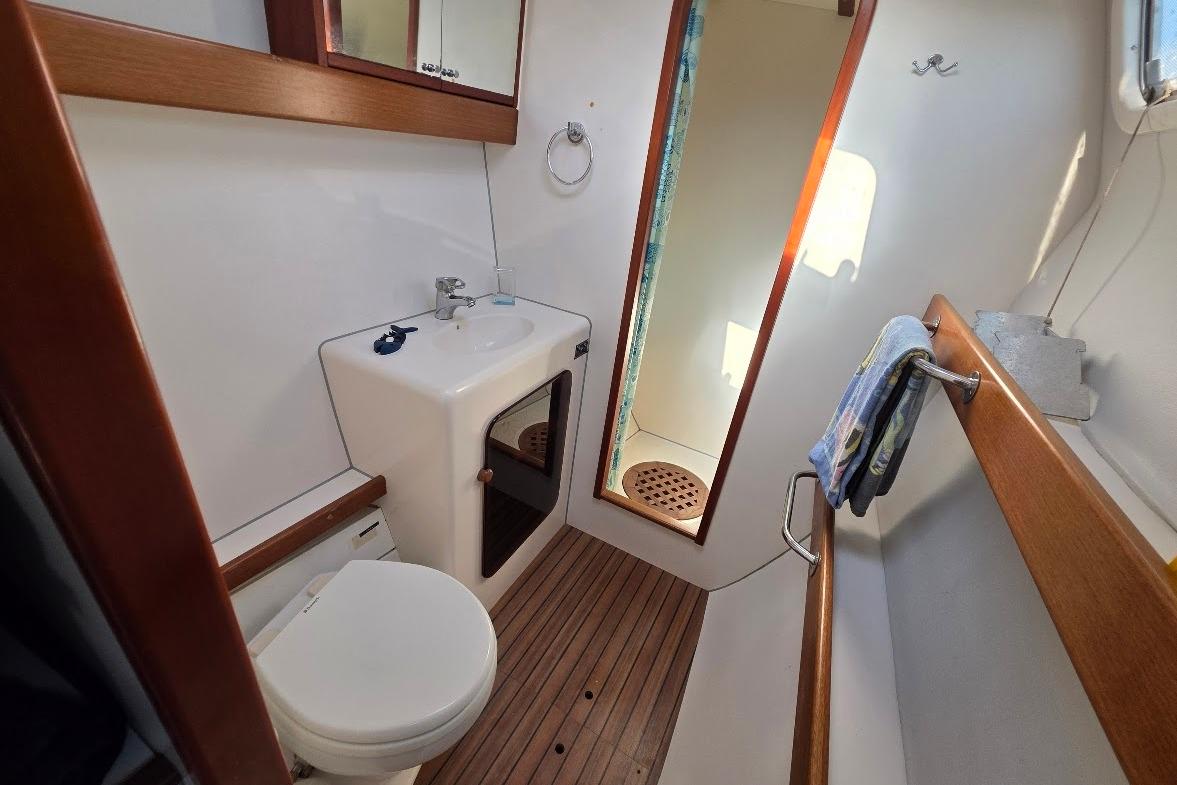 Bathroom interior of 2003 Outremer 45 yacht with sink, toilet, and shower.
