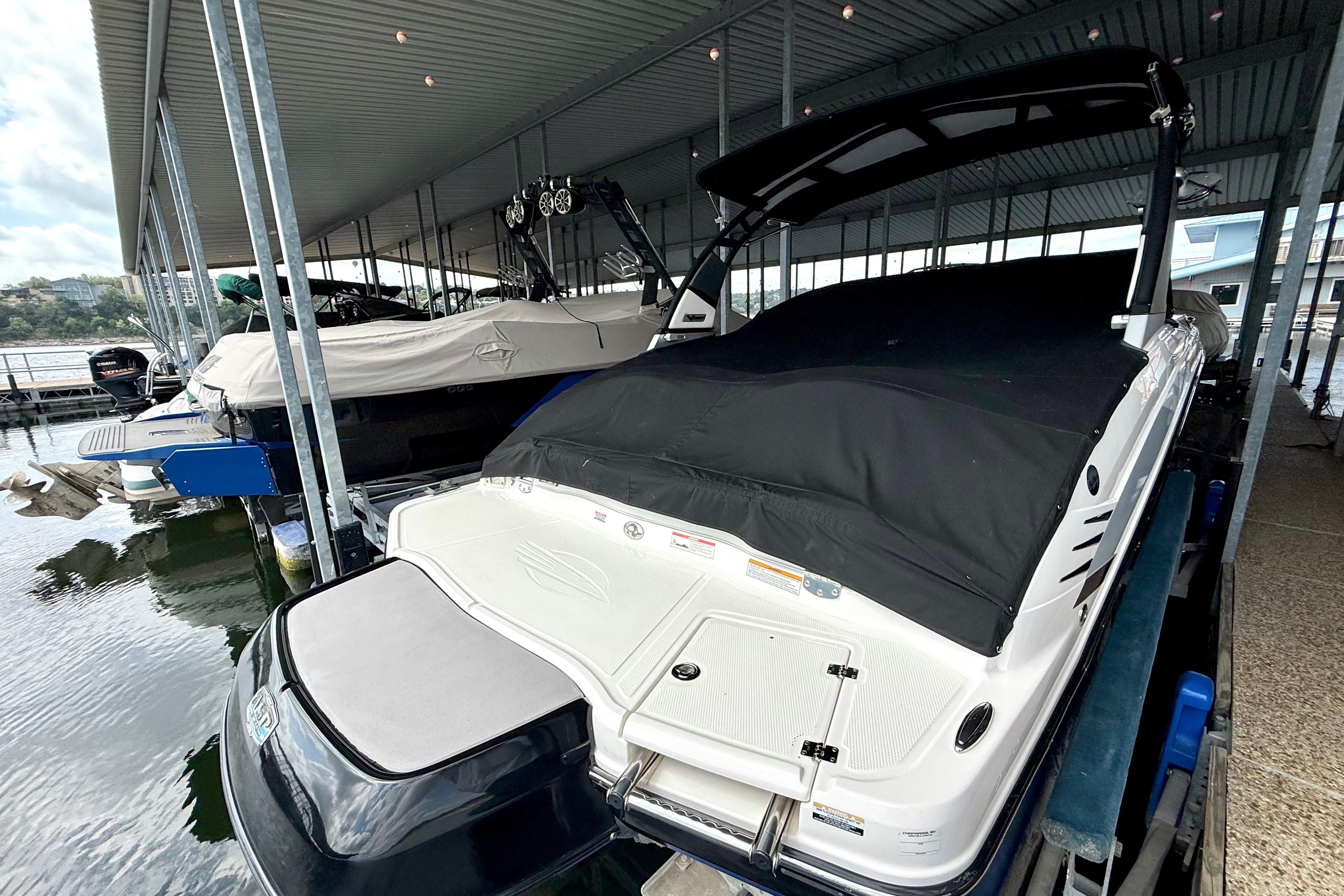 2019 Chaparral Vortex 223 VRX boat docked under a covered marina.