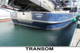 Transom view of 1979 Custom Longliner 58 boat docked in water.