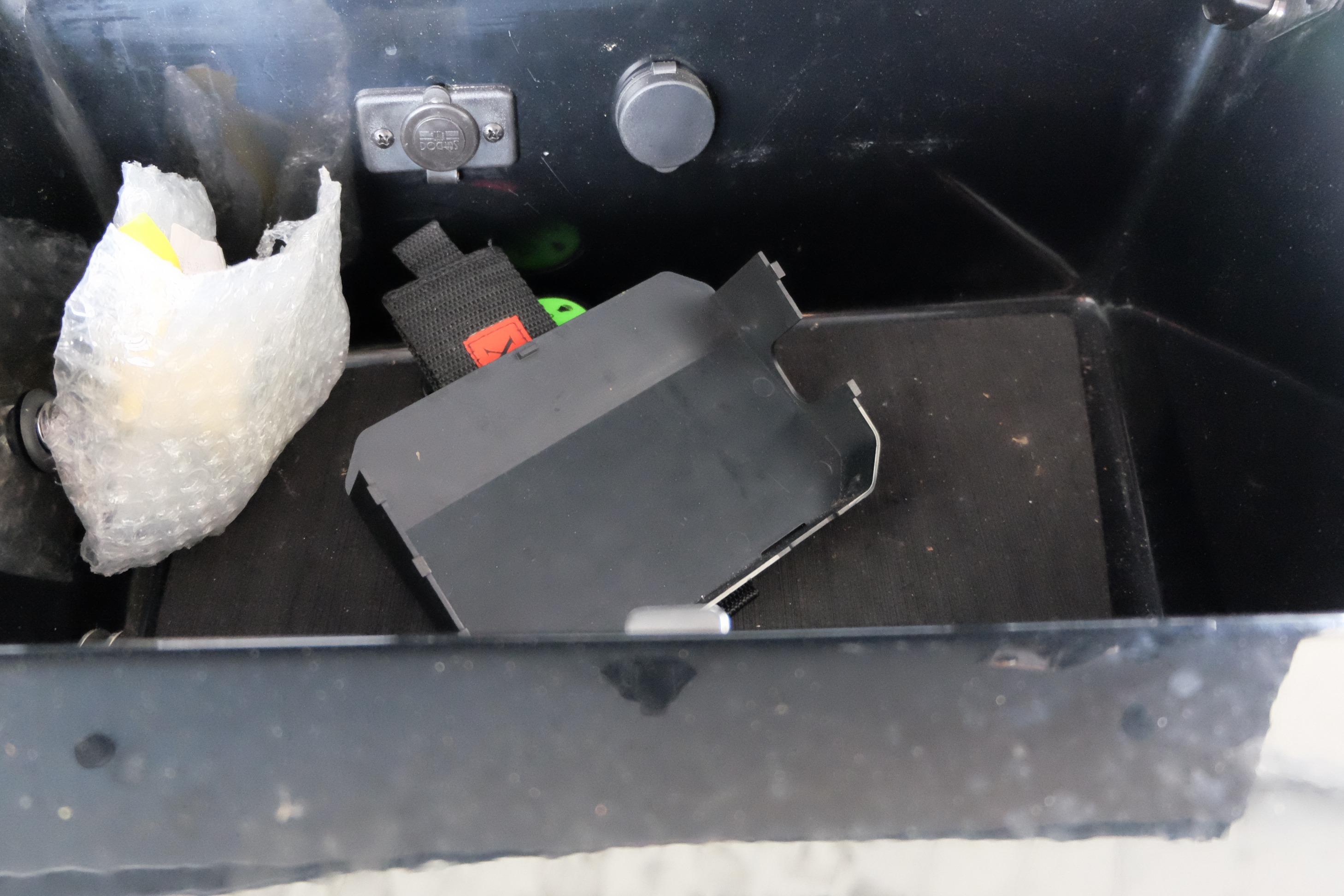 Storage compartment in a 2020 Malibu Wakesetter 23 LSV boat with bubble wrap and accessories.