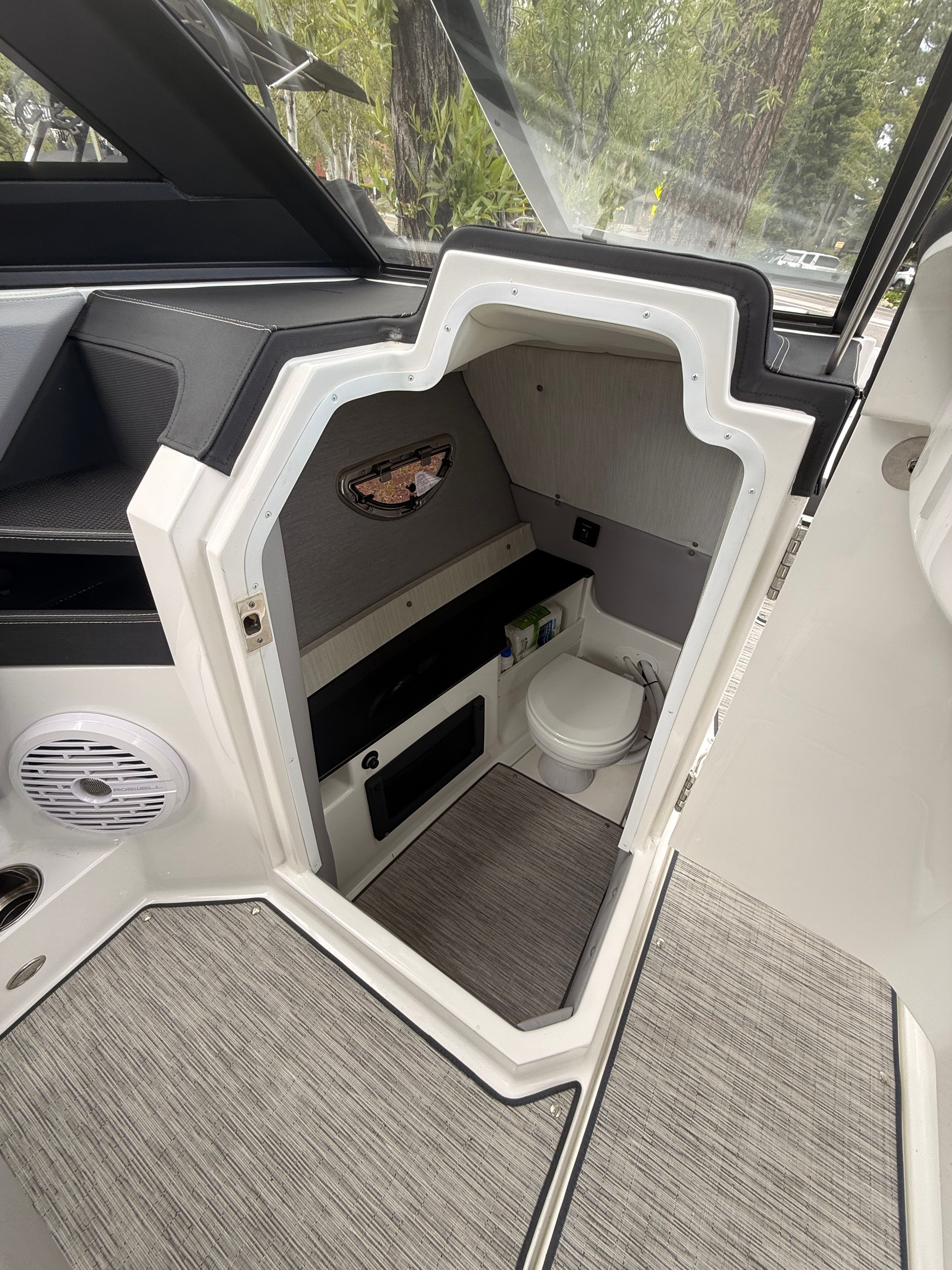 Interior view of a 2022 Cobalt R8 Surf featuring a small toilet and gray flooring.
