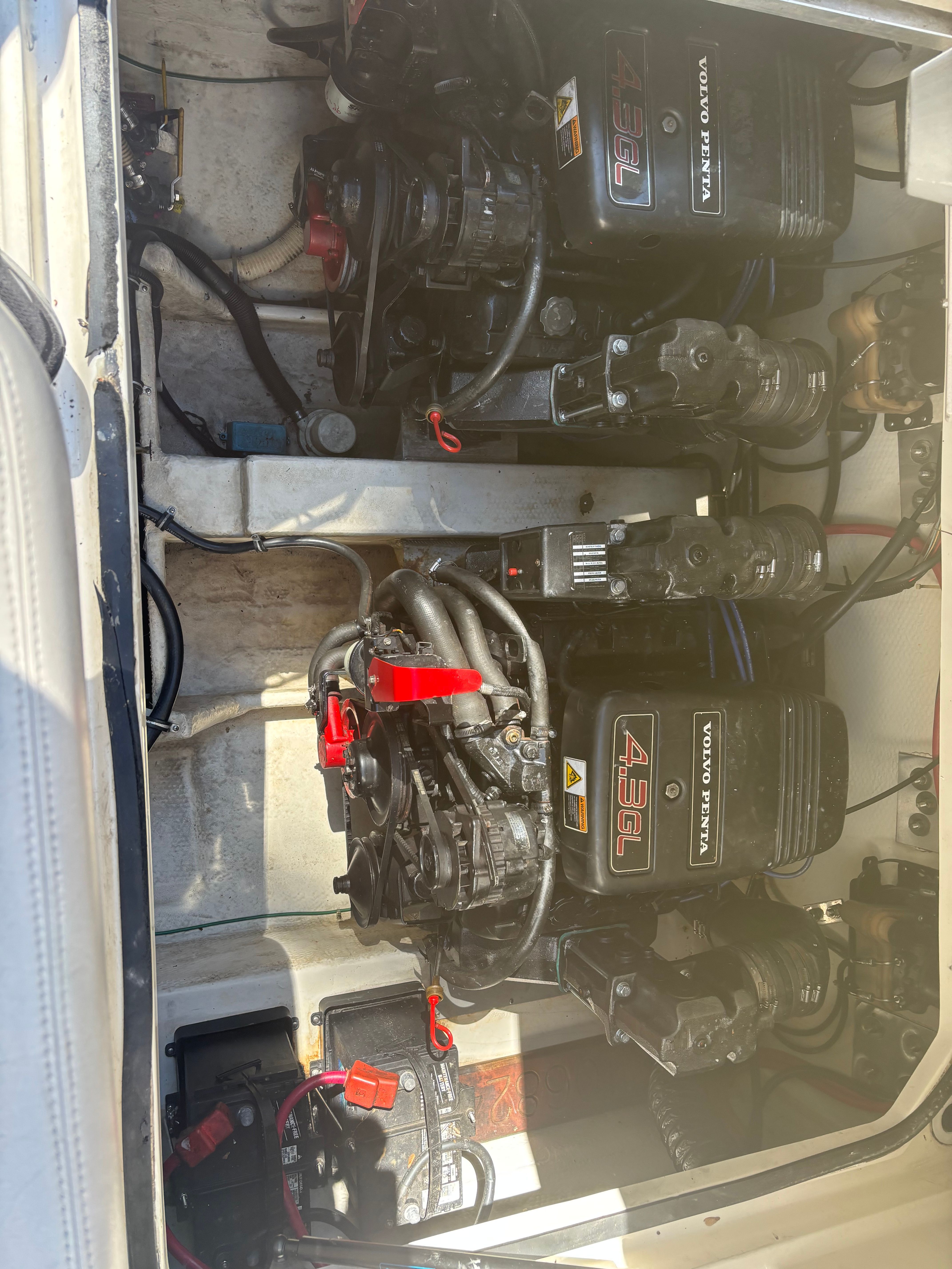 Two Volvo Penta engines in a boat's engine compartment, clean and well-organized.