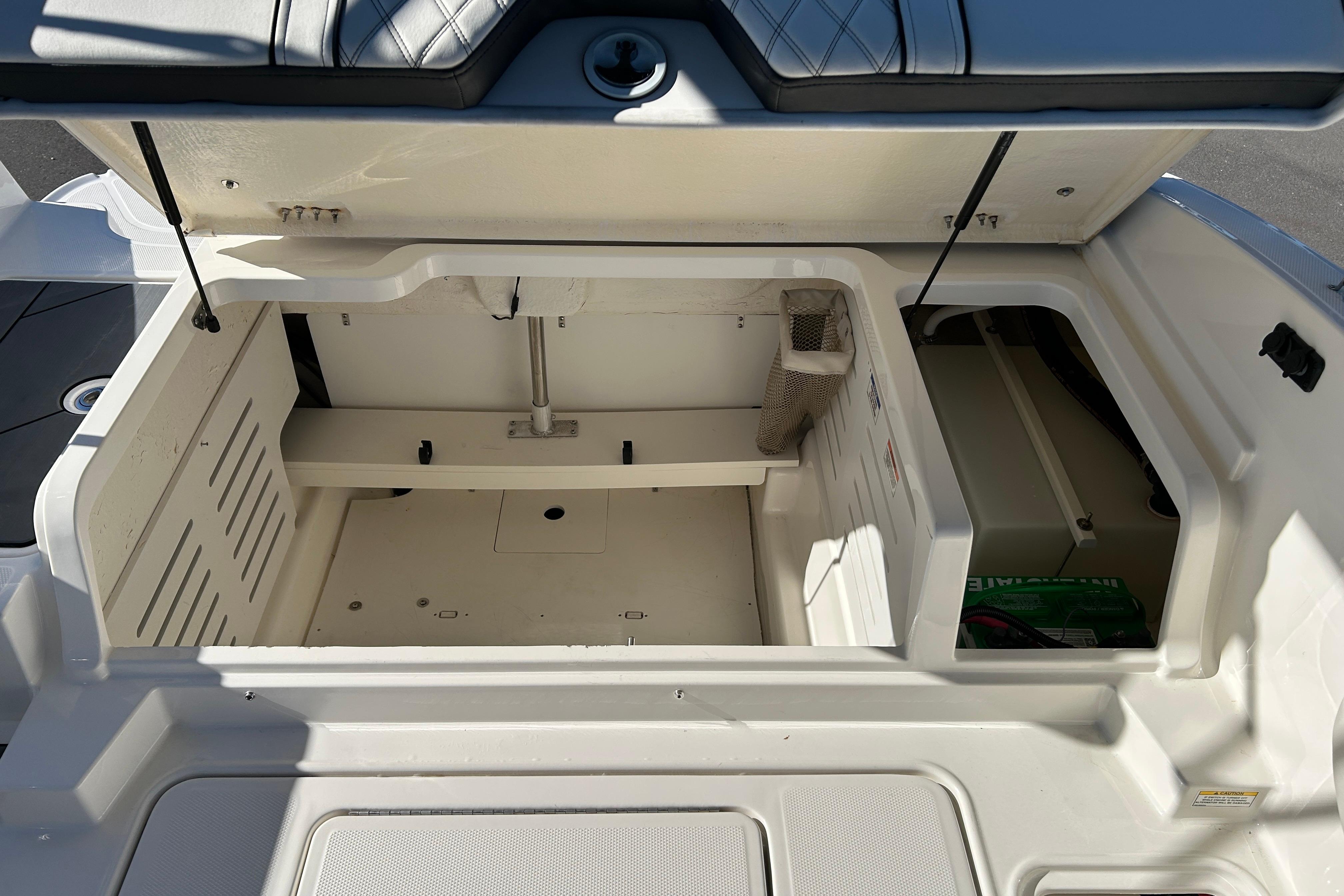 Open storage compartment of a 2020 Bayliner DX 2000 boat, showcasing interior space.