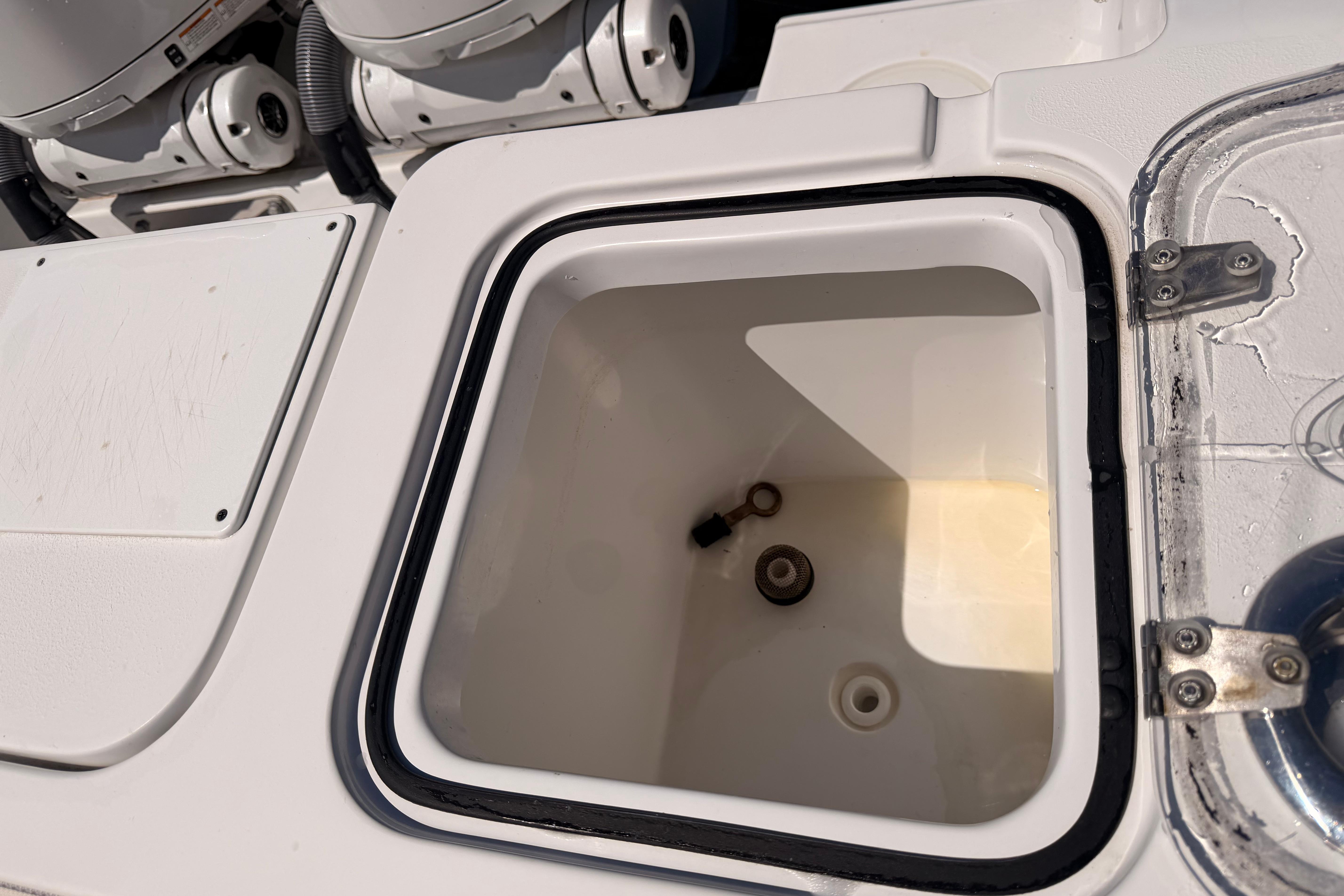 2024 Sea Hunt Gamefish 27 Coffin Box interior, showcasing storage compartment details.