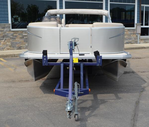 2018 Tahoe LTZ 2285 CR pontoon boat on trailer, parked in front of a building.